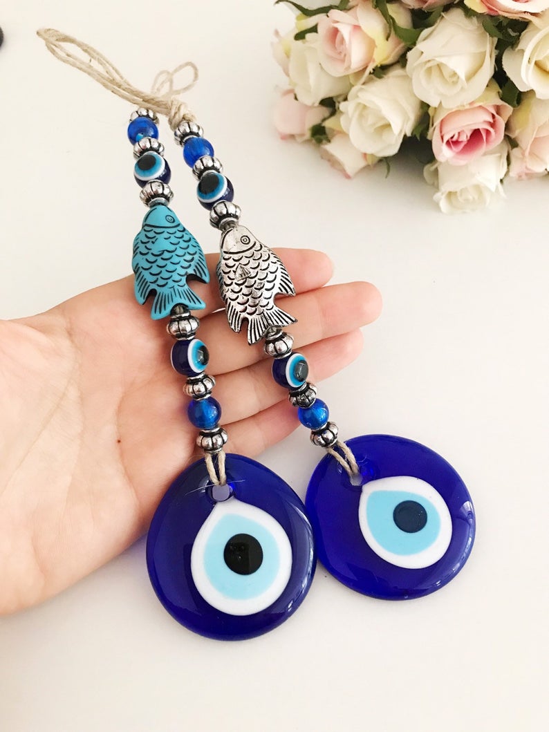 Handmade Evil Eye Wall Hanging featuring a fish lucky charm in silver and turquoise colors, measuring 27cm in length.