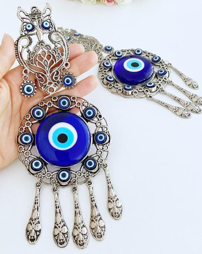 Handmade Evil Eye Wall Hanging featuring an owl charm, crafted with metal and glass beads, symbolizing good luck and protection.