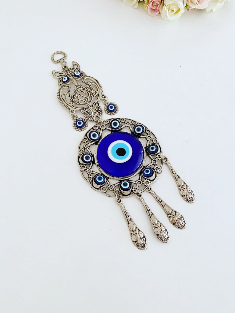 Handmade Evil Eye Wall Hanging featuring an owl charm, crafted with metal and glass beads, symbolizing good luck and protection.