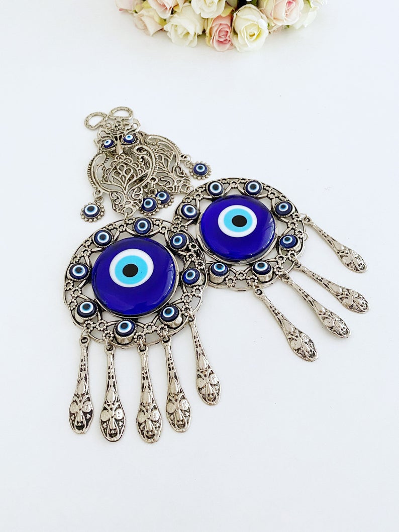 Handmade Evil Eye Wall Hanging featuring an owl charm, crafted with metal and glass beads, symbolizing good luck and protection.