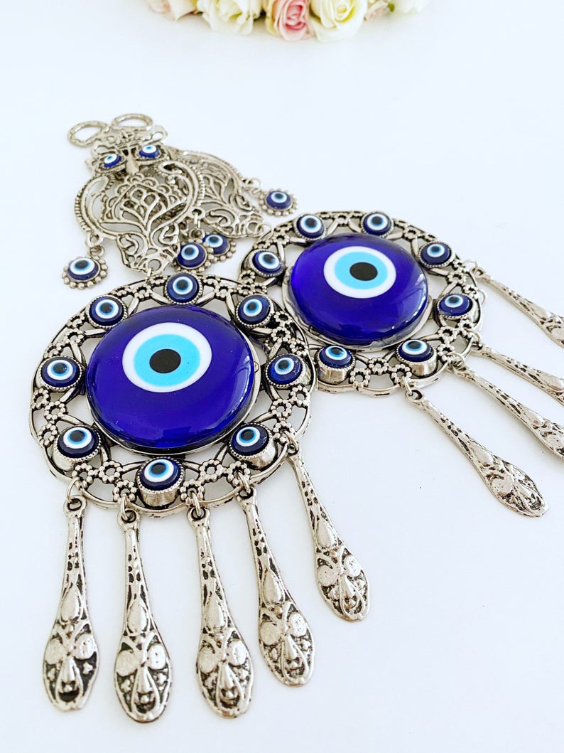 Handmade Evil Eye Wall Hanging featuring an owl charm, crafted with metal and glass beads, symbolizing good luck and protection.