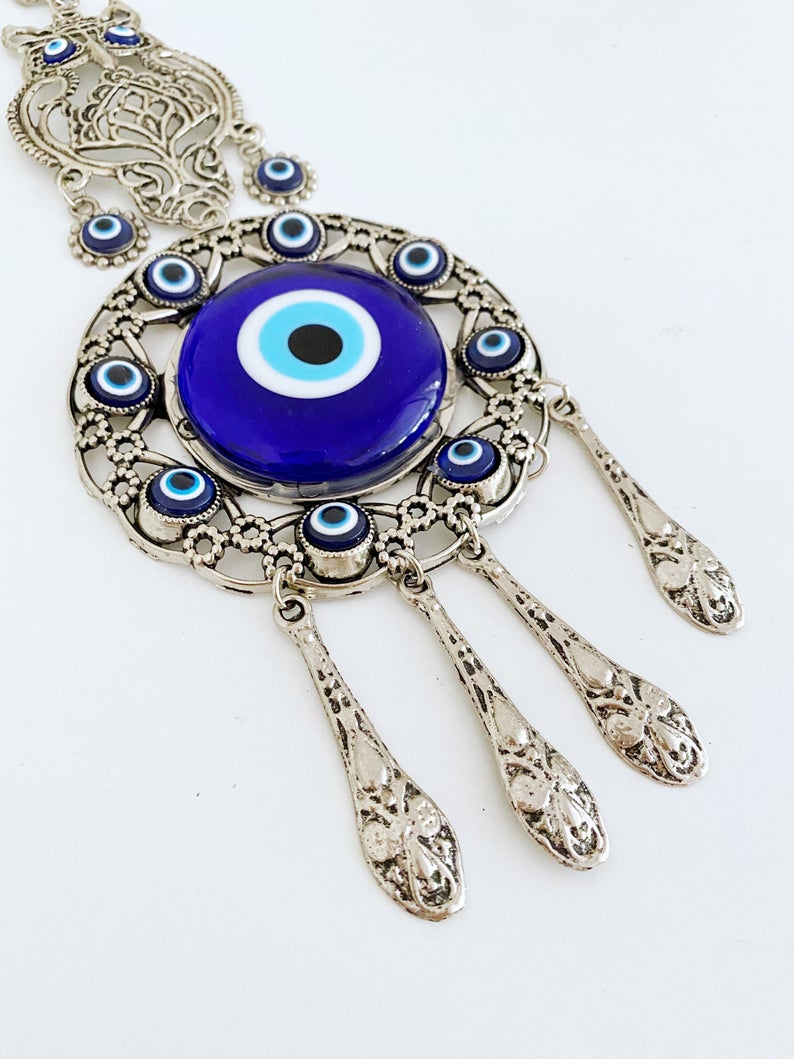 Handmade Evil Eye Wall Hanging featuring an owl charm, crafted with metal and glass beads, symbolizing good luck and protection.