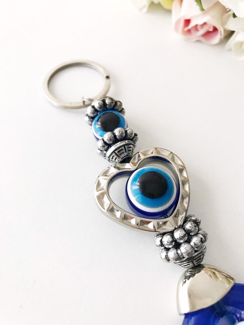 Evileye heart charm keychain featuring a heart and evil eye design, perfect for keys or bags.