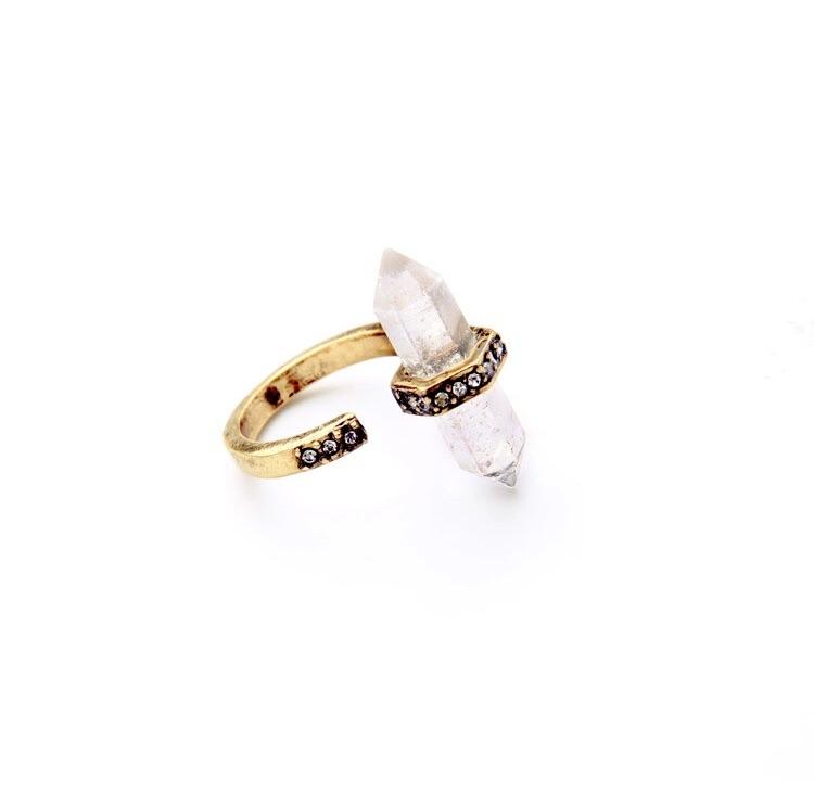 Evolve Ring featuring a clear quartz point wrapped in rhinestones with an antique gold finish, showcasing its unique design and elegance.