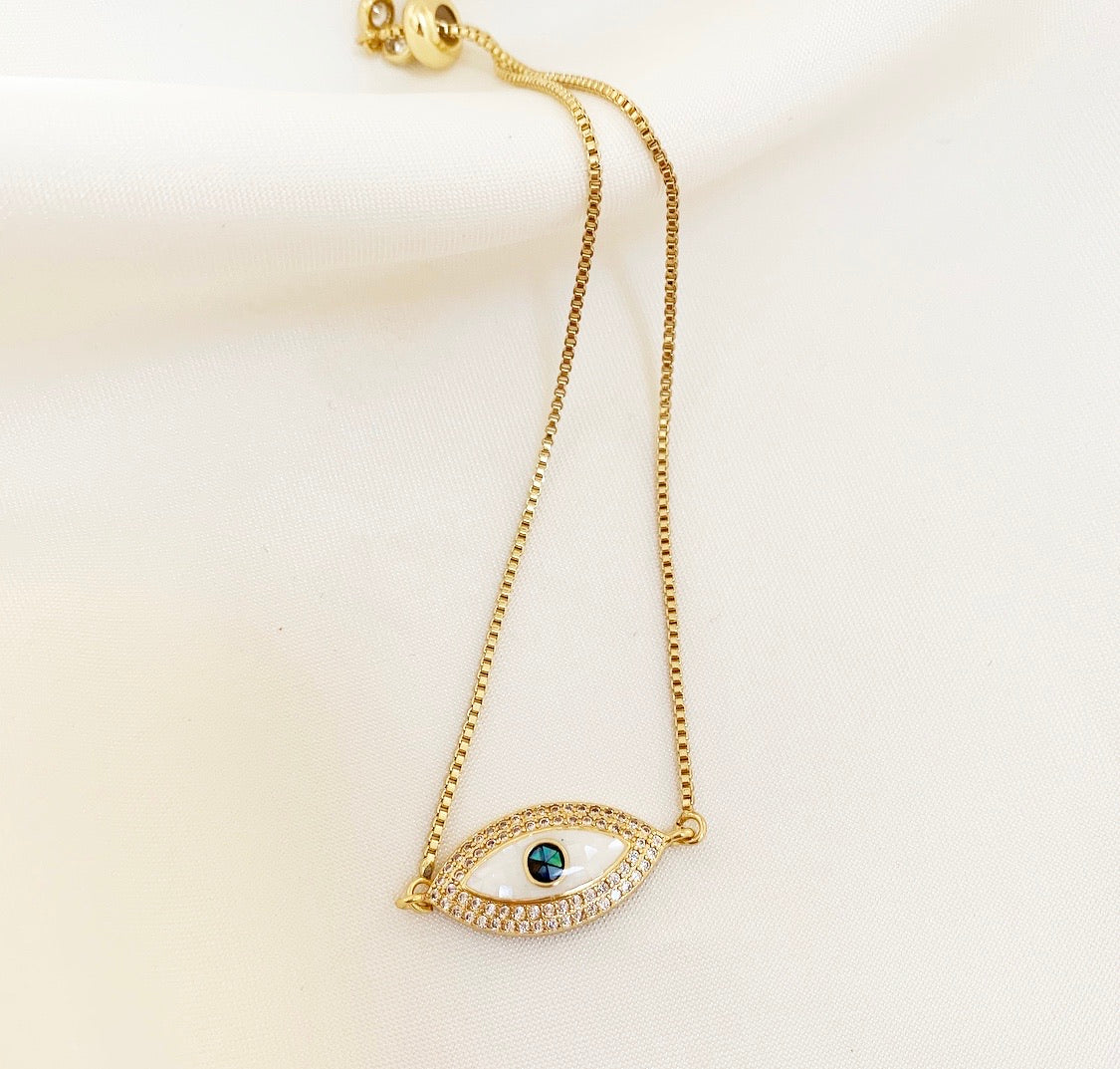 EZRA Bracelet featuring an evil eye design with sparkling cubic zirconia stones and a gold-plated brass finish.