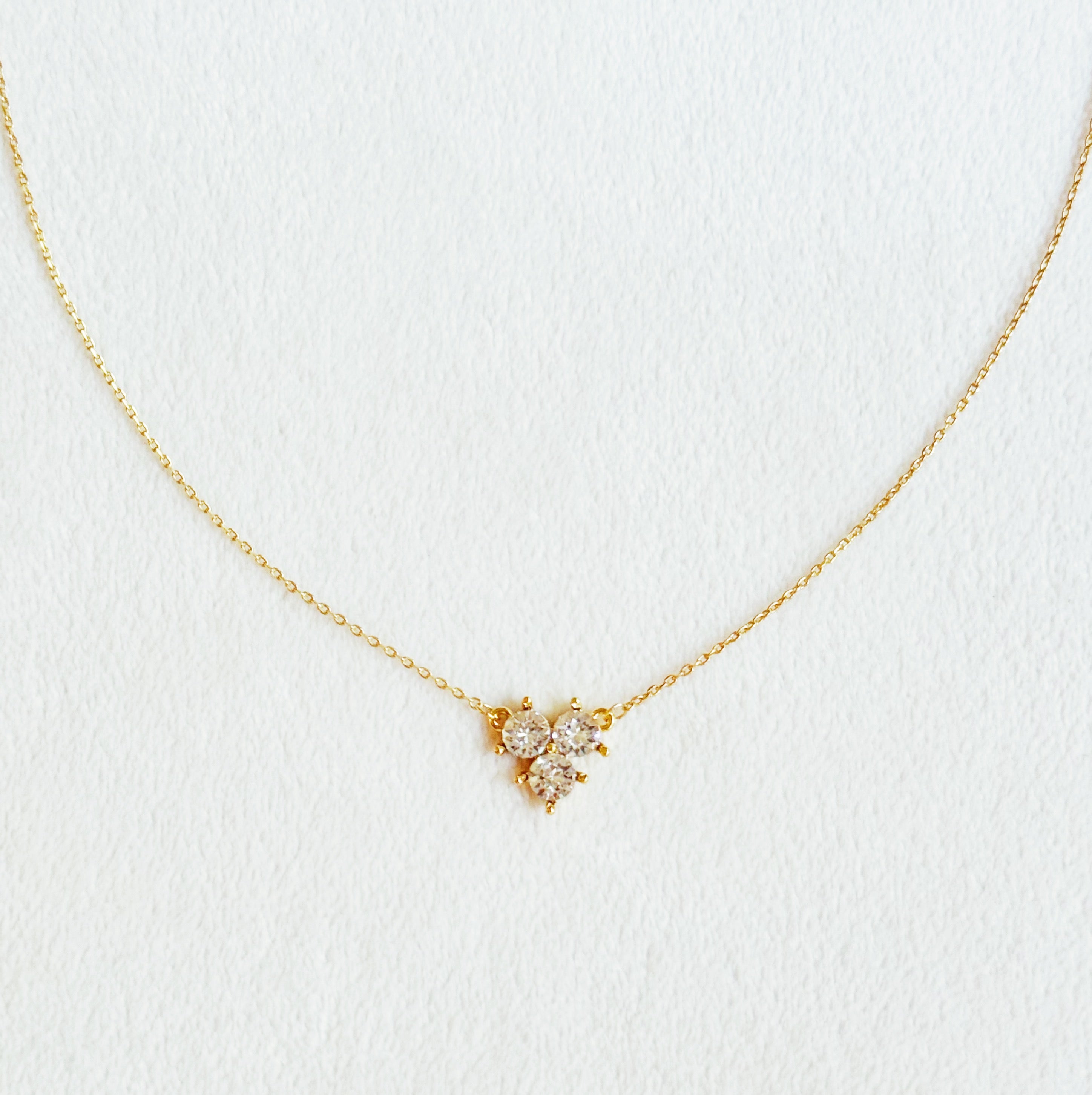 Elegant Faceted Trio Crystals Necklace featuring three sparkling crystals on a gold plated chain.