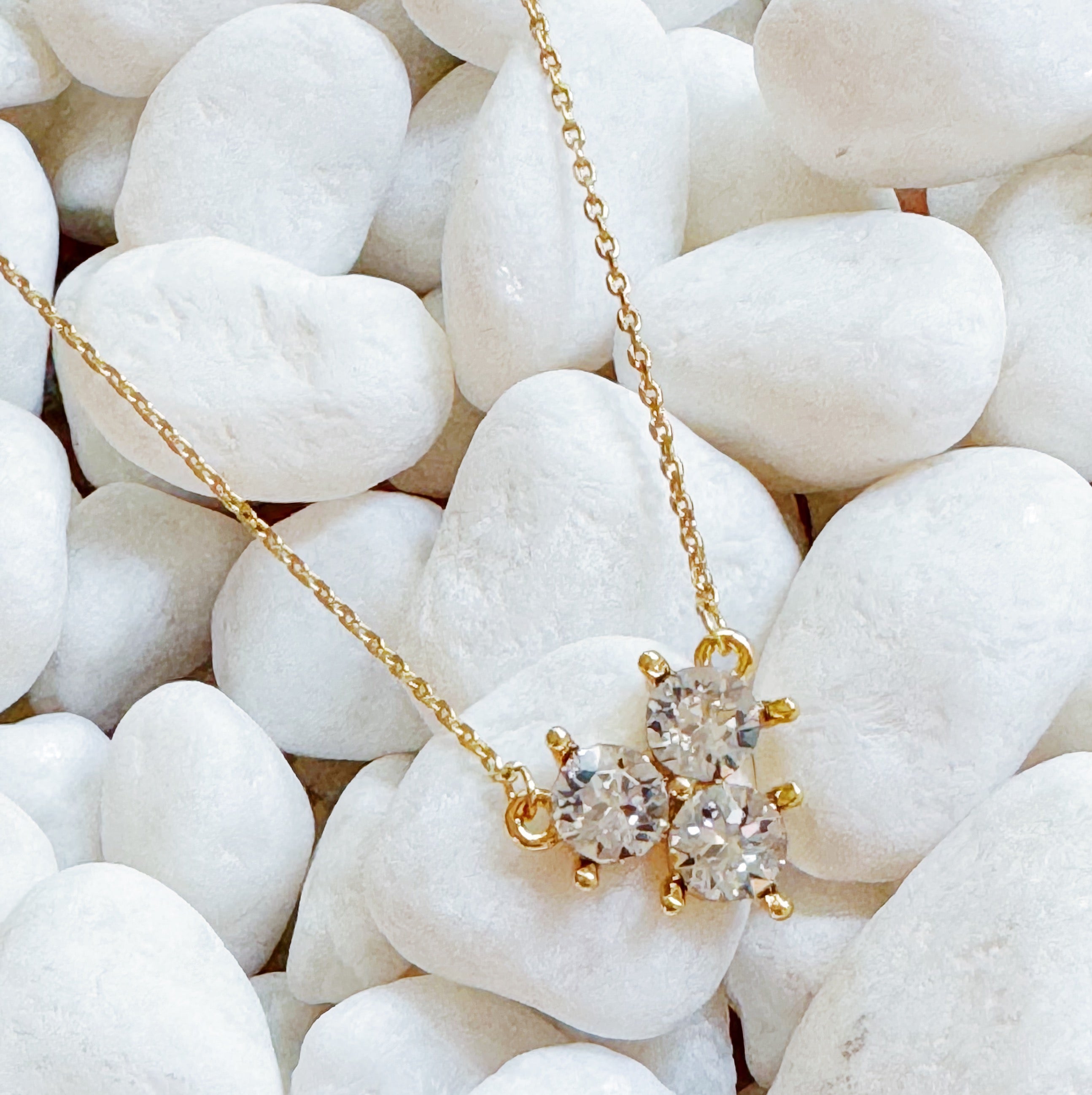 Elegant Faceted Trio Crystals Necklace featuring three sparkling crystals on a gold plated chain.