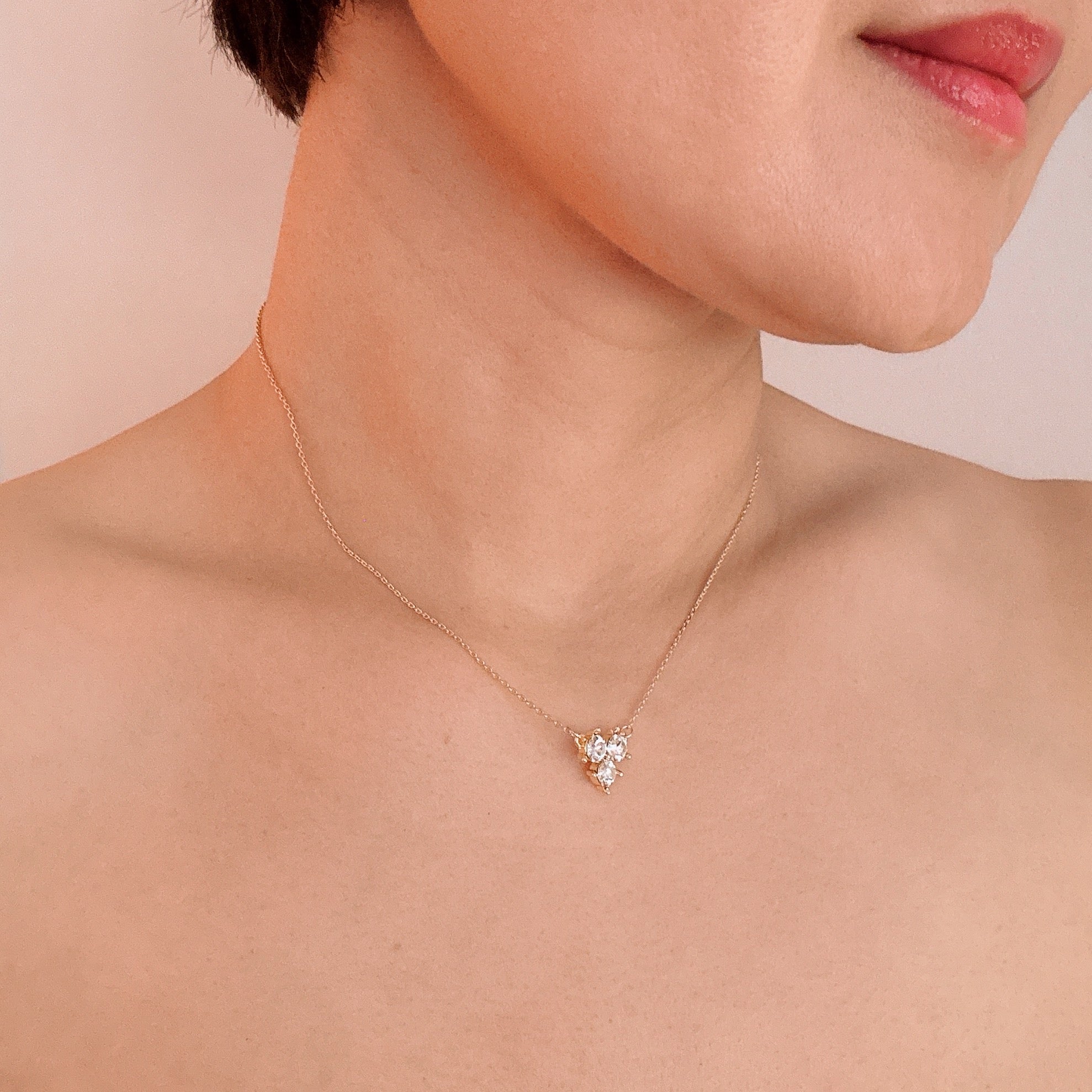 Elegant Faceted Trio Crystals Necklace featuring three sparkling crystals on a gold plated chain.