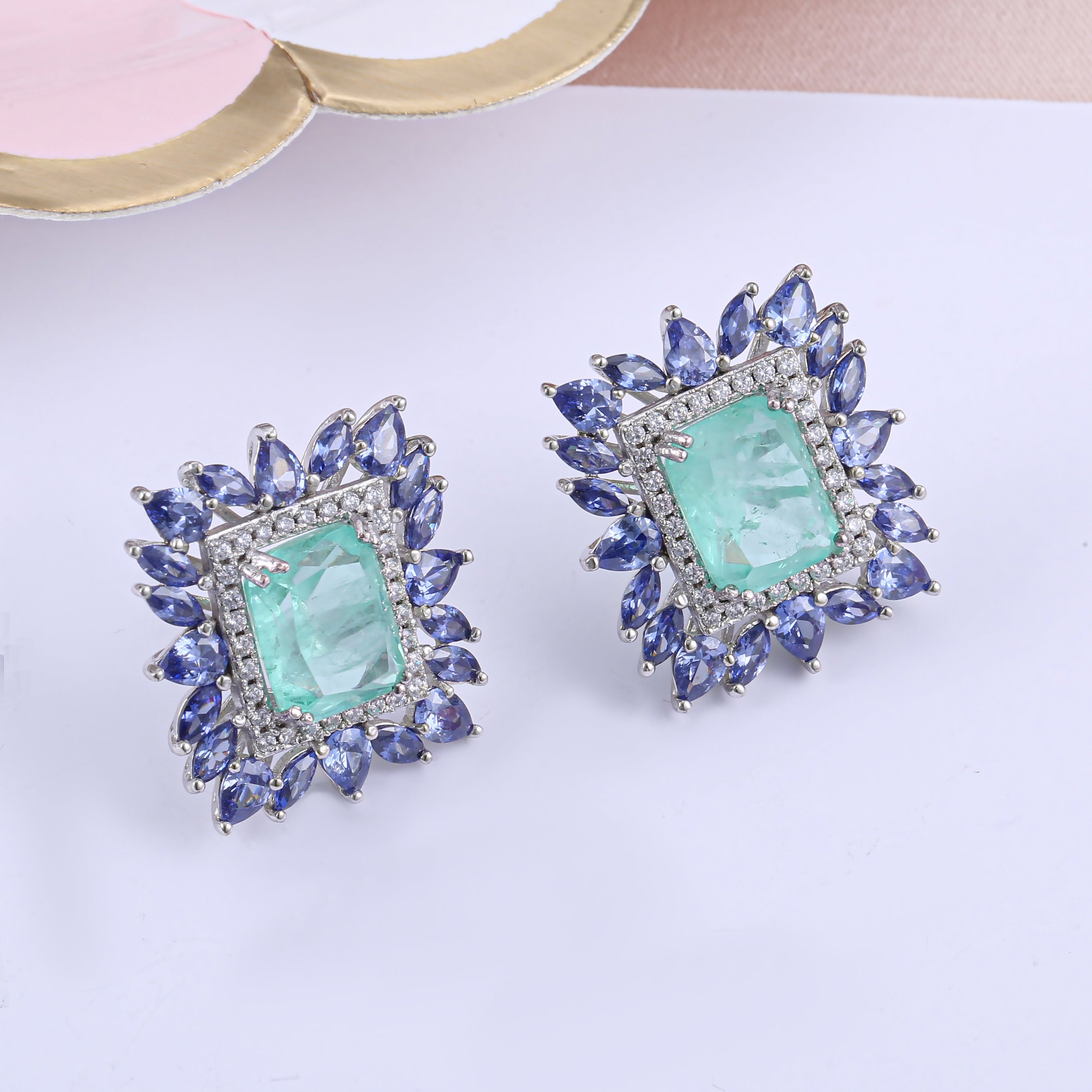 Elegant Fancy Square Earrings made of 925 sterling silver with white gold finish and adorned with white sapphire and paraiba stones.