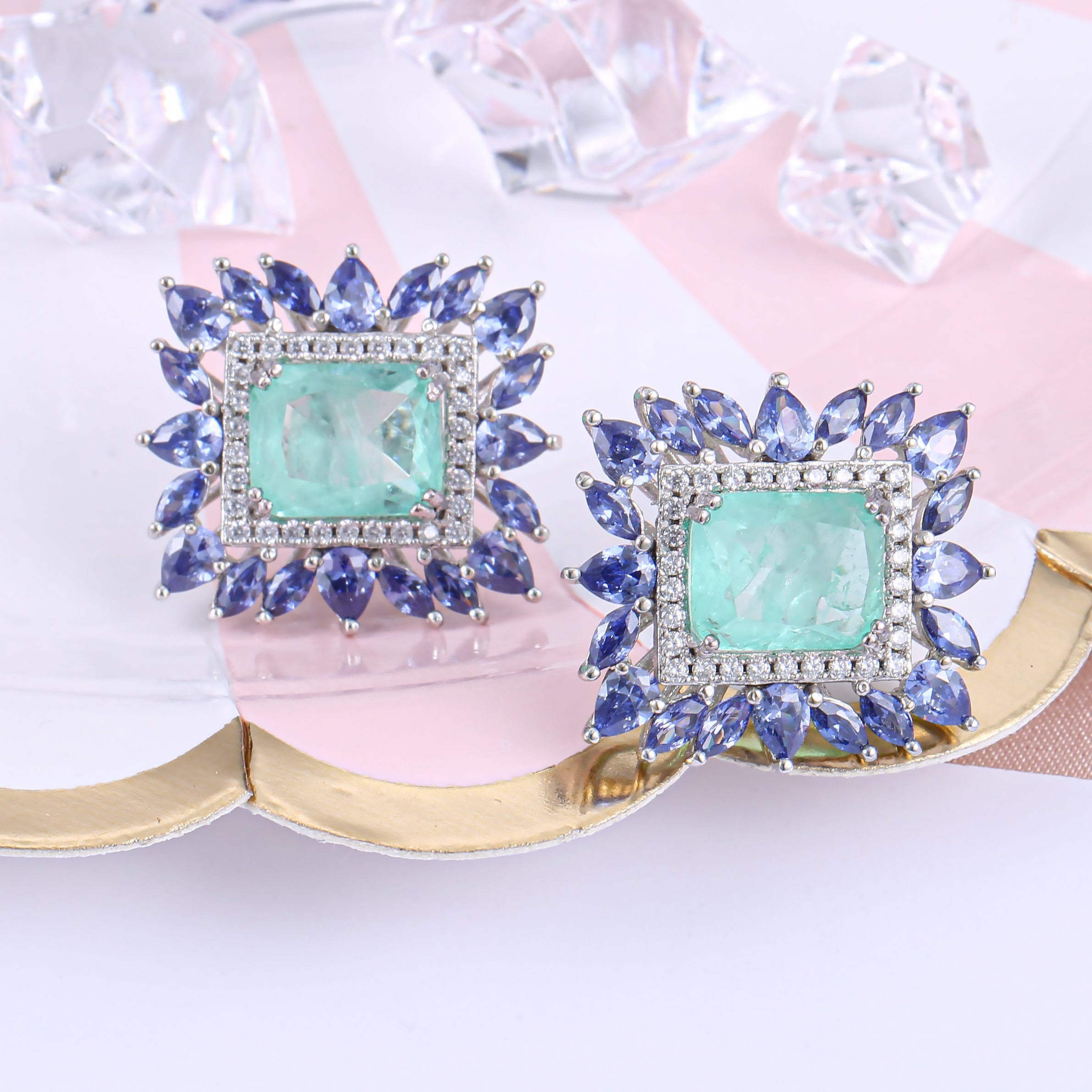 Elegant Fancy Square Earrings made of 925 sterling silver with white gold finish and adorned with white sapphire and paraiba stones.