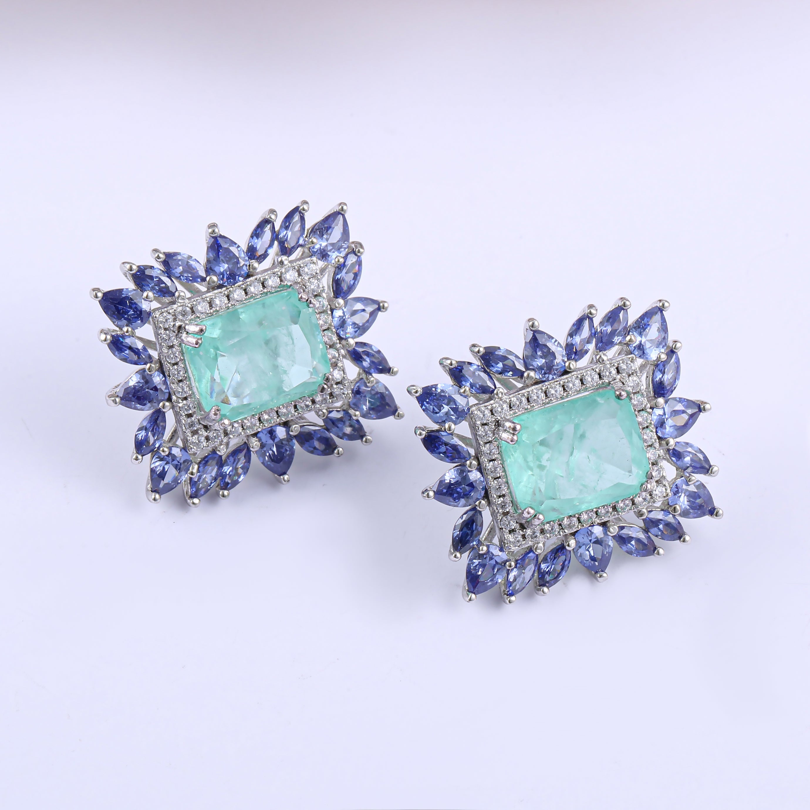 Elegant Fancy Square Earrings made of 925 sterling silver with white gold finish and adorned with white sapphire and paraiba stones.