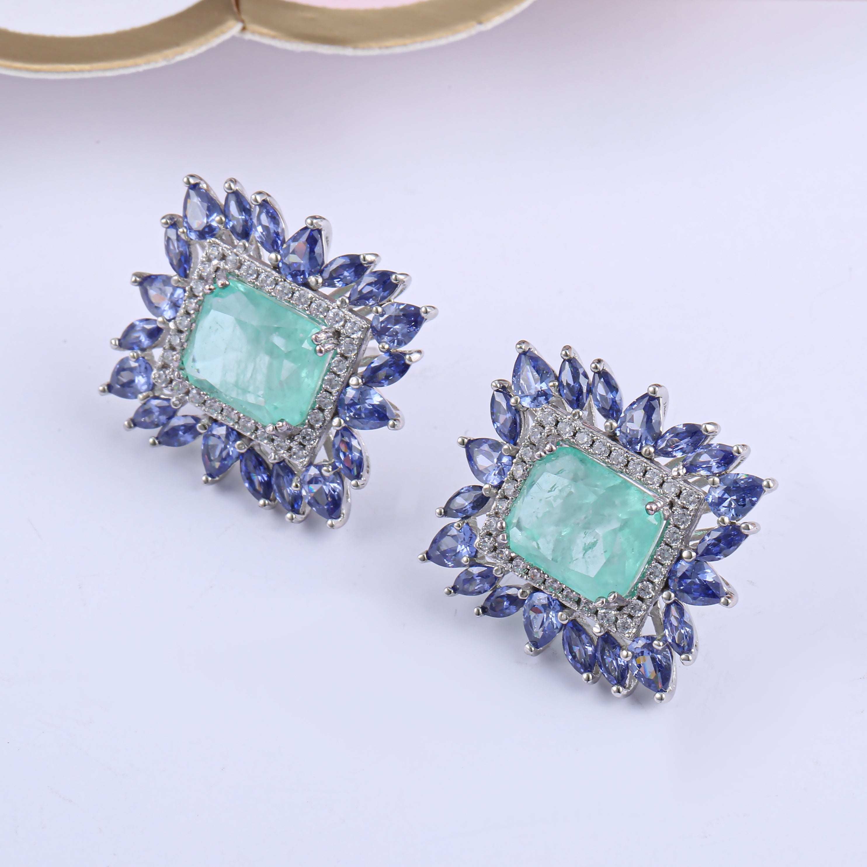 Elegant Fancy Square Earrings made of 925 sterling silver with white gold finish and adorned with white sapphire and paraiba stones.