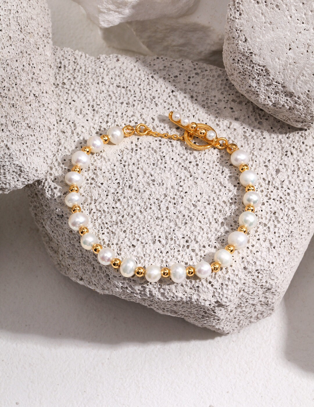 Fashionable Freshwater Pearl Decor Beaded Bracelet featuring natural pearls and gold vermeil accents, elegantly displayed on a soft surface.