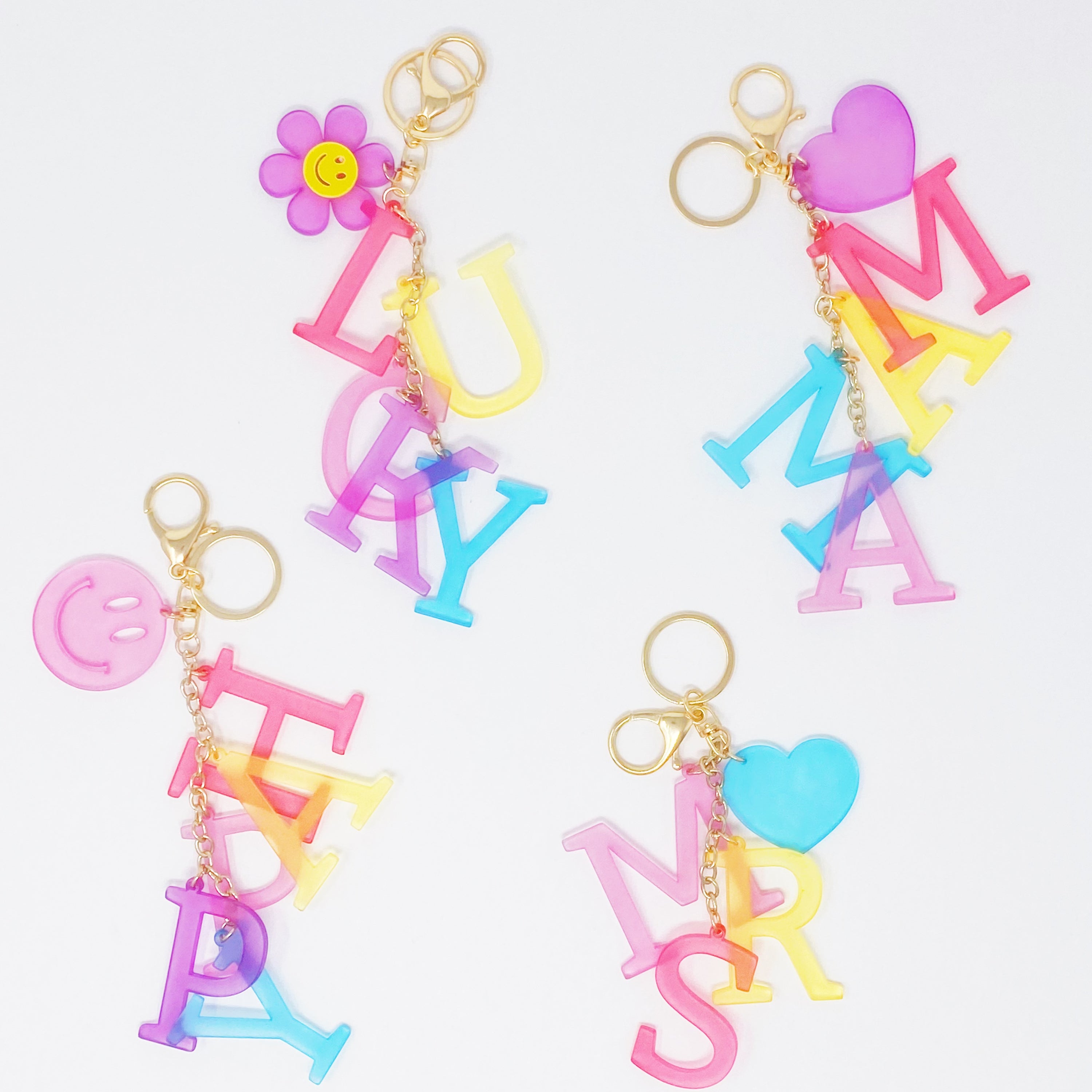 A stylish Favorite Word Jingle Key Chain featuring beautifully cut-out letters and gold tone hardware, perfect for keys or as a bag charm.