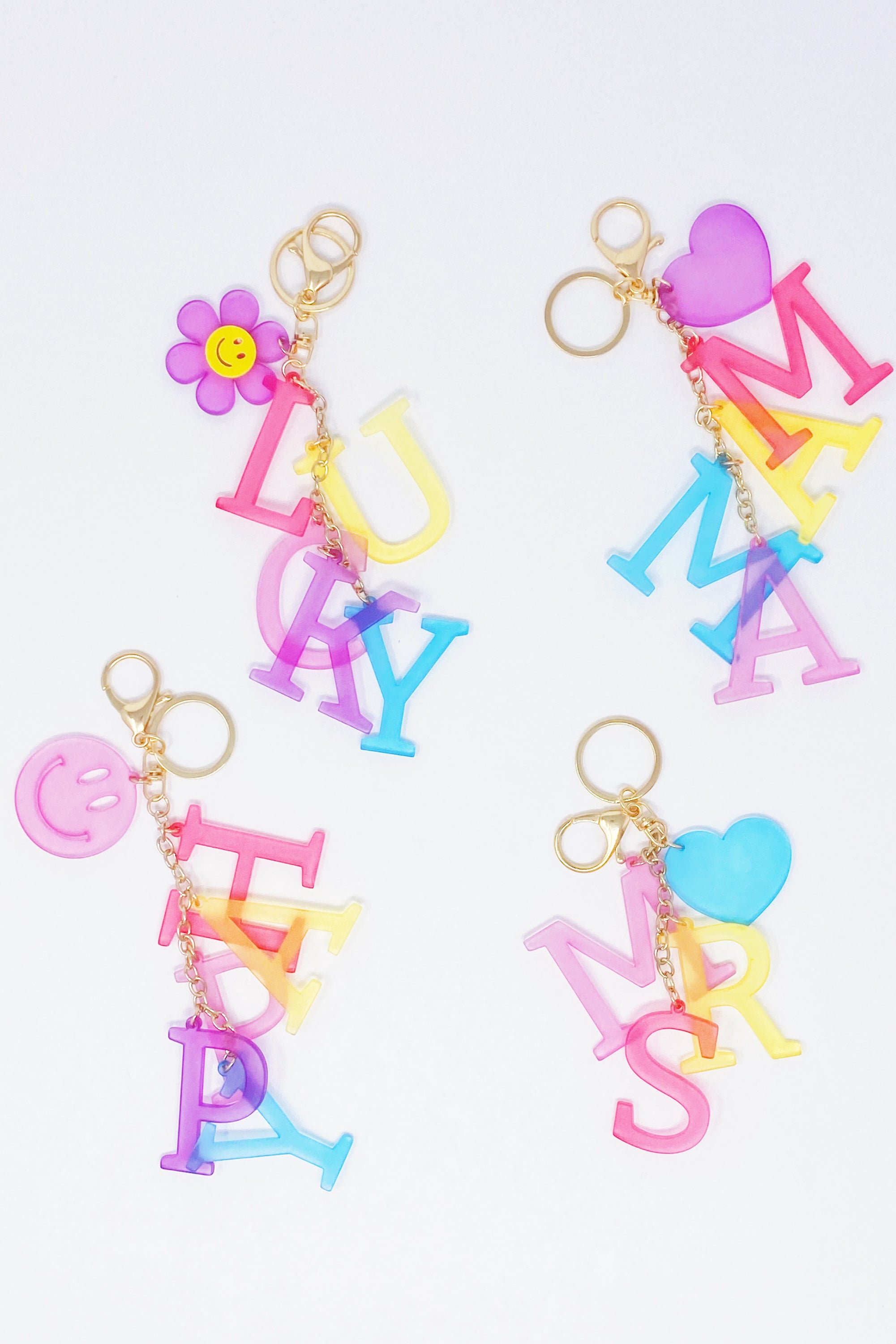 A stylish Favorite Word Jingle Key Chain featuring beautifully cut-out letters and gold tone hardware, perfect for keys or as a bag charm.