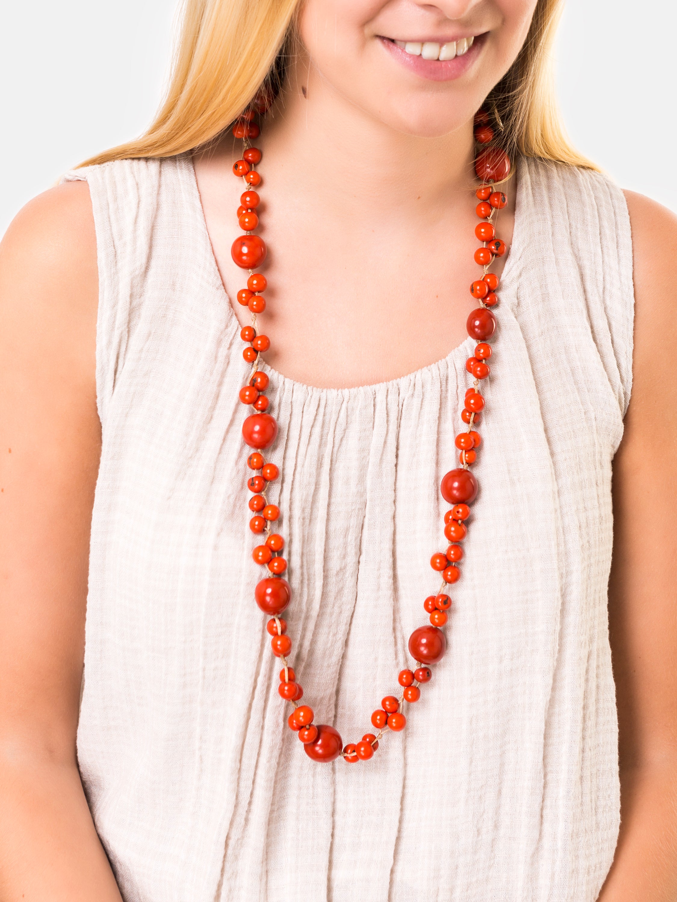 Feliz Necklace Long featuring colorful acai seeds and tagua nuts, elegantly displayed in eco-friendly packaging.