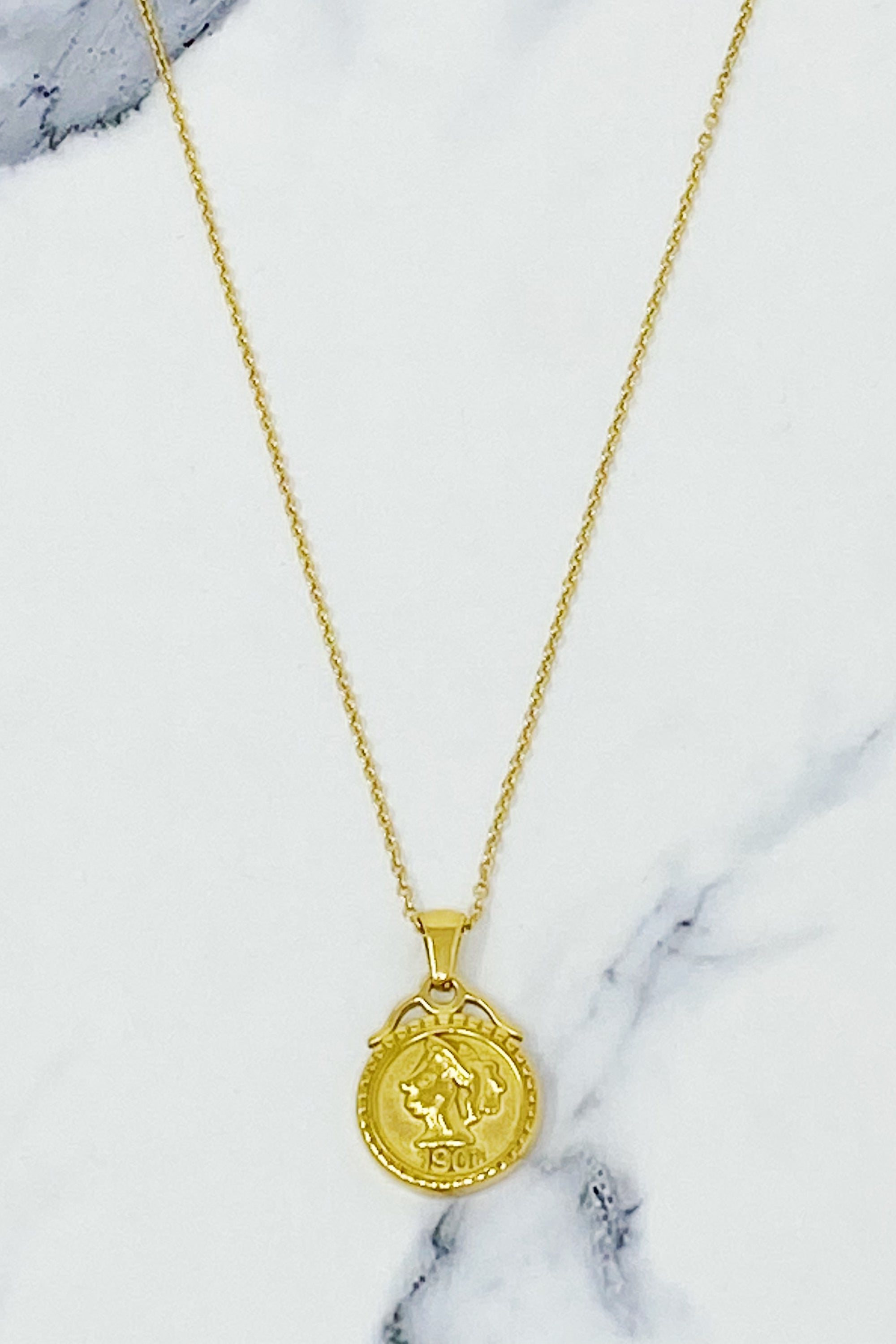 Feminine Coined Necklace featuring a detailed coin pendant with a female silhouette, crafted in 18K gold plated stainless steel.