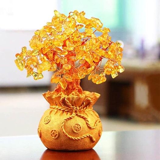 A beautiful Feng Shui Citrine Money Tree with crystal leaves and a golden money bag base, symbolizing wealth and prosperity.