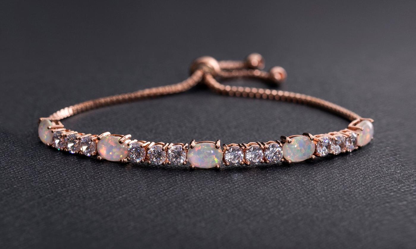 A stunning Fiery Opal Tennis Bracelet featuring genuine opal and sparkling crystals, elegantly plated in 18K white gold.