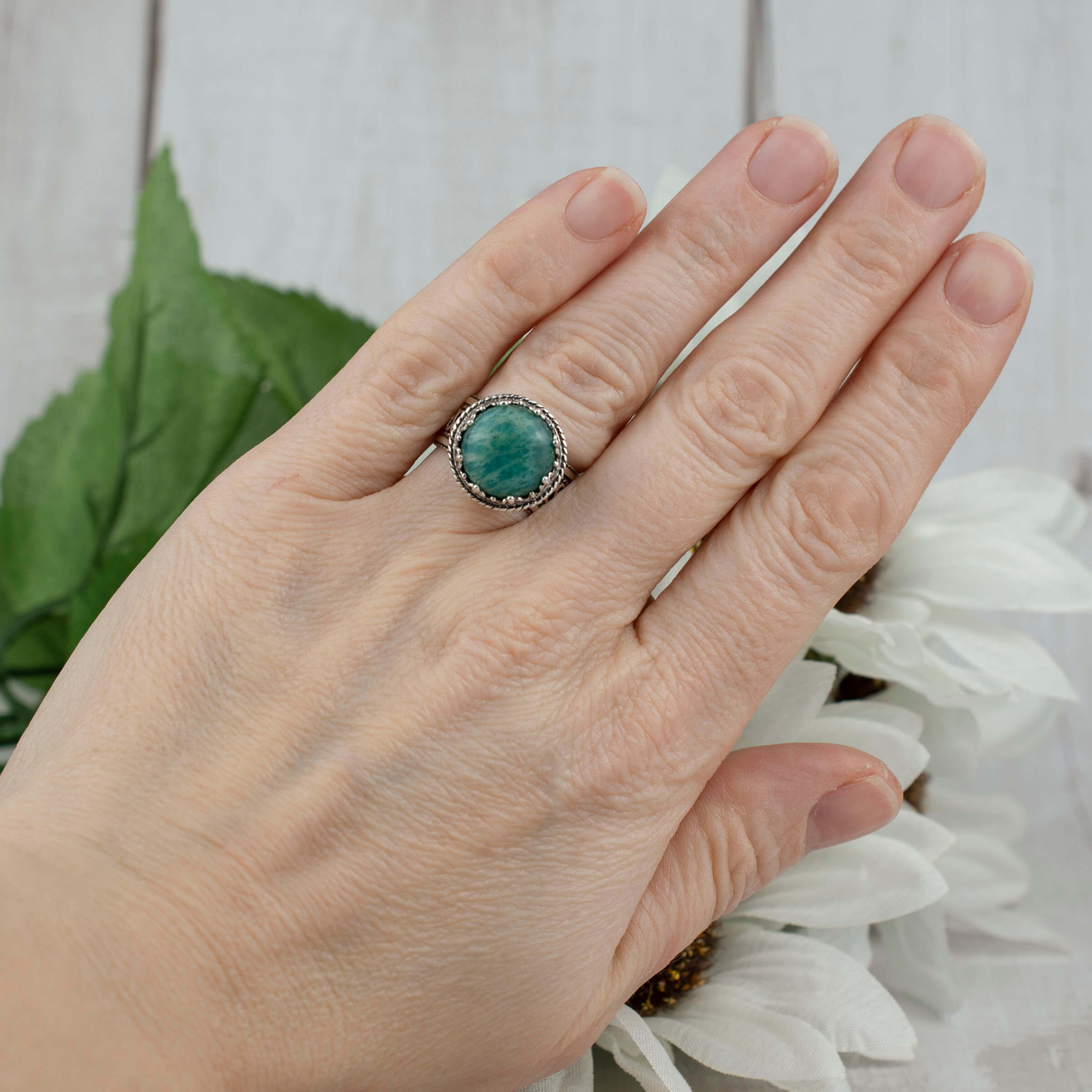 Elegant sterling silver filigree cocktail ring featuring a round 12 mm Amazonite gemstone, showcasing intricate metalwork.