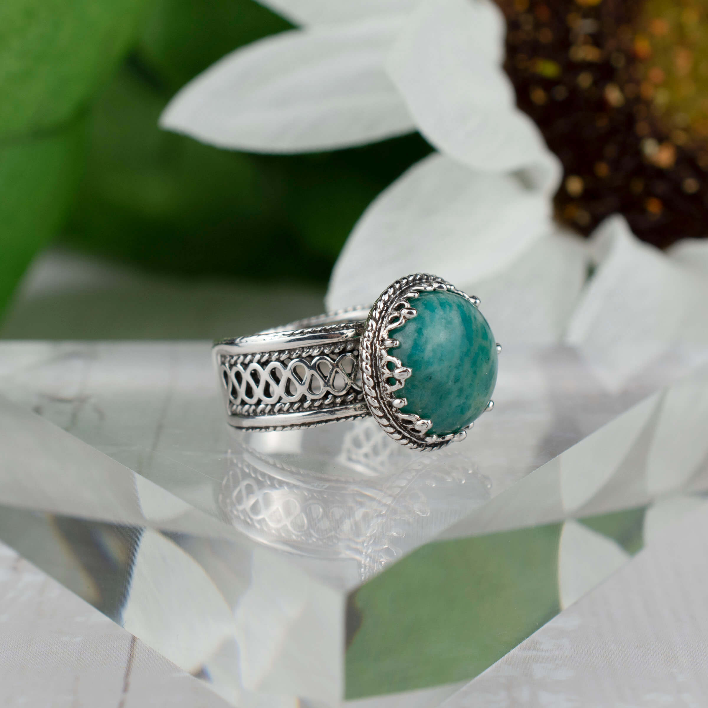 Elegant sterling silver filigree cocktail ring featuring a round 12 mm Amazonite gemstone, showcasing intricate metalwork.