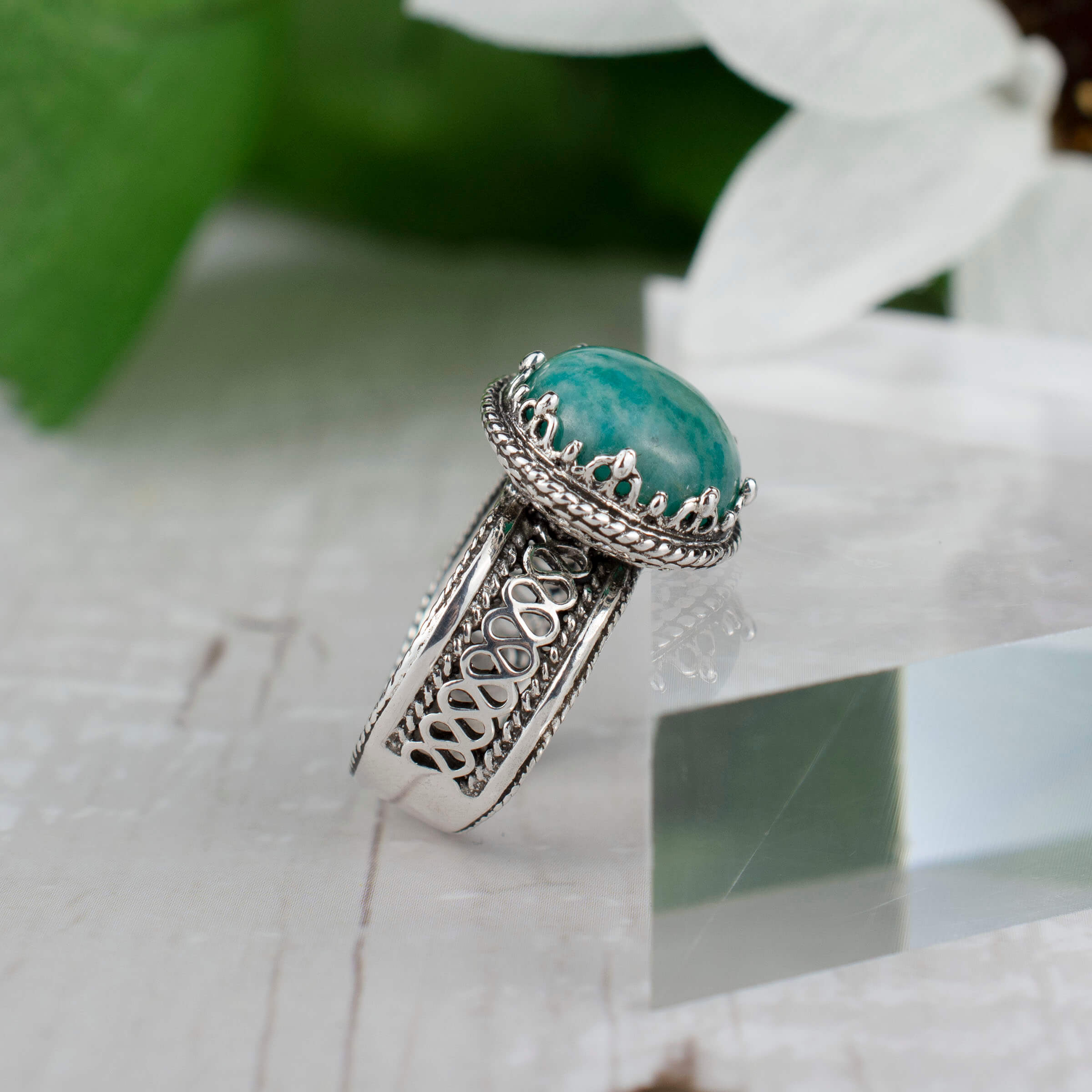 Elegant sterling silver filigree cocktail ring featuring a round 12 mm Amazonite gemstone, showcasing intricate metalwork.