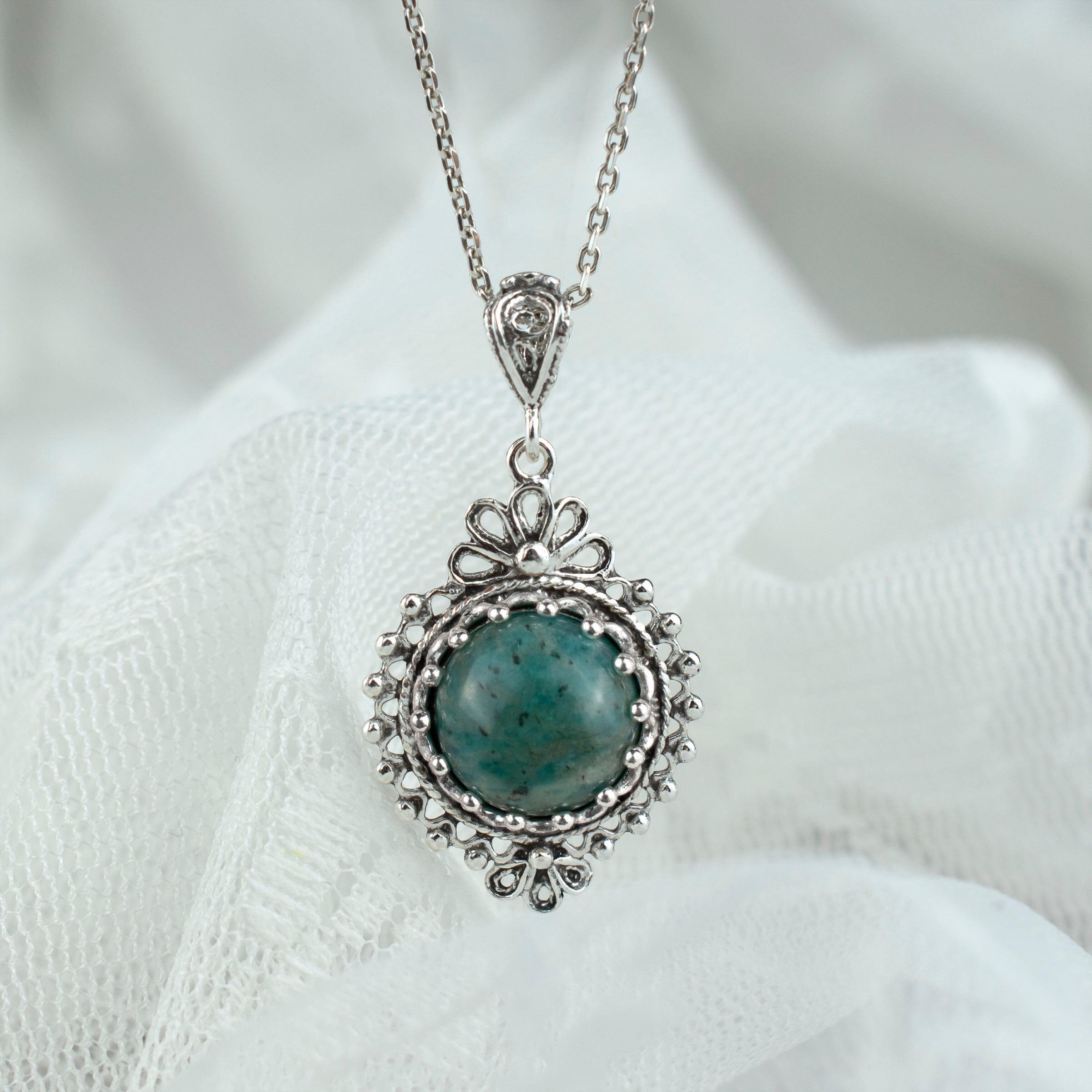 Elegant silver boho pendant necklace featuring a natural amazonite gemstone in a delicate filigree design.