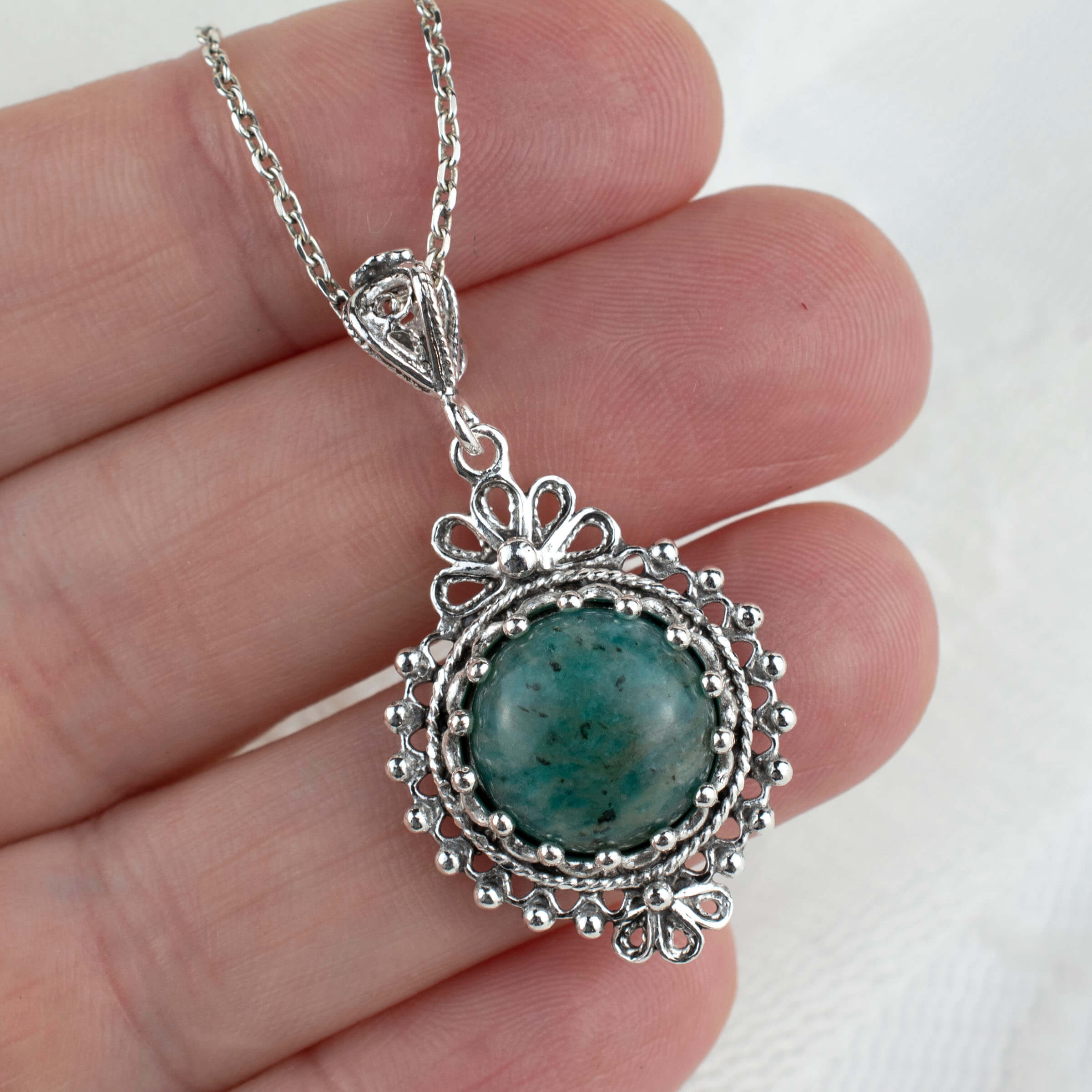 Elegant silver boho pendant necklace featuring a natural amazonite gemstone in a delicate filigree design.