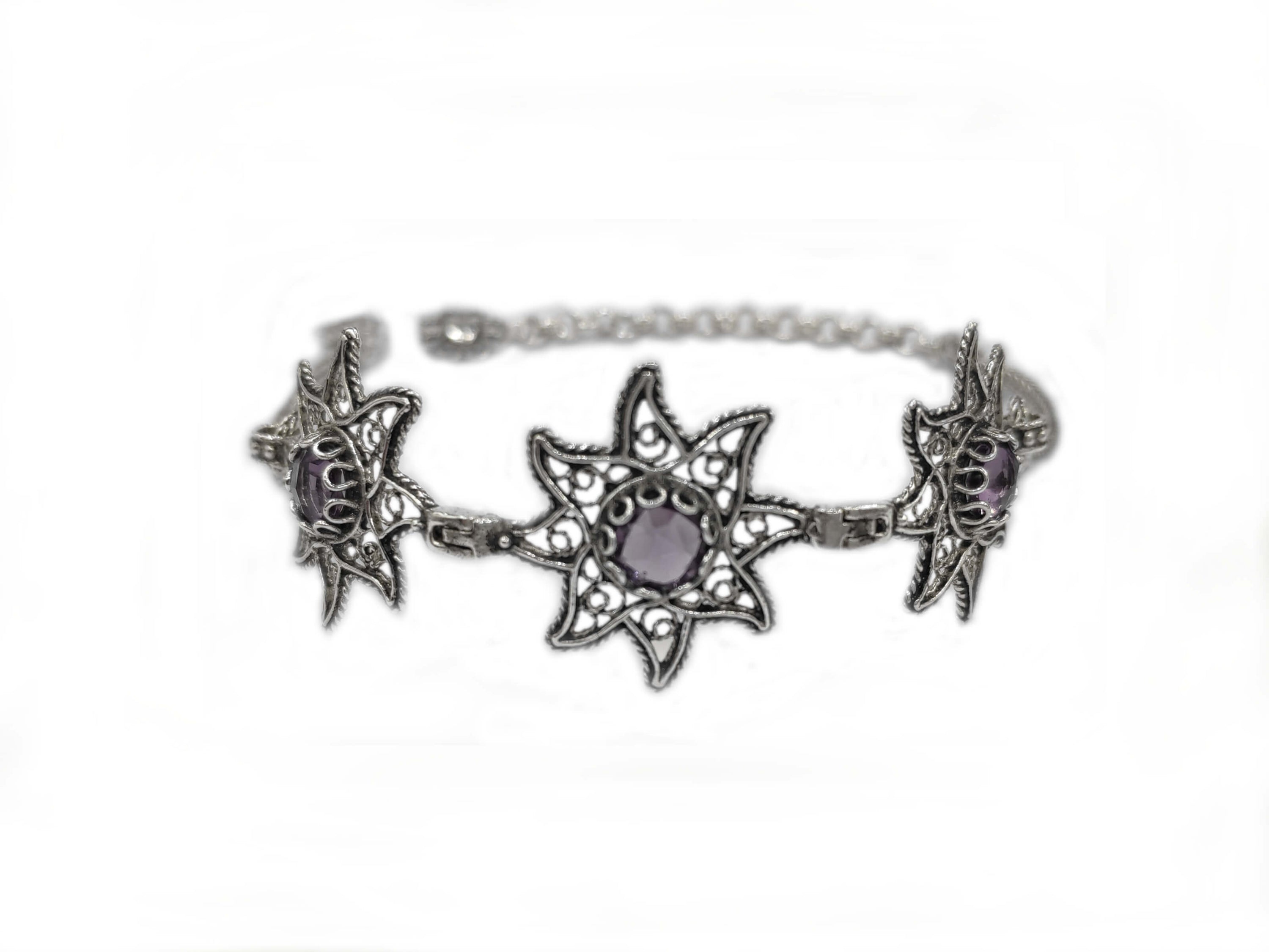 Sterling silver filigree bracelet featuring amethyst gemstones, showcasing intricate design and elegance.