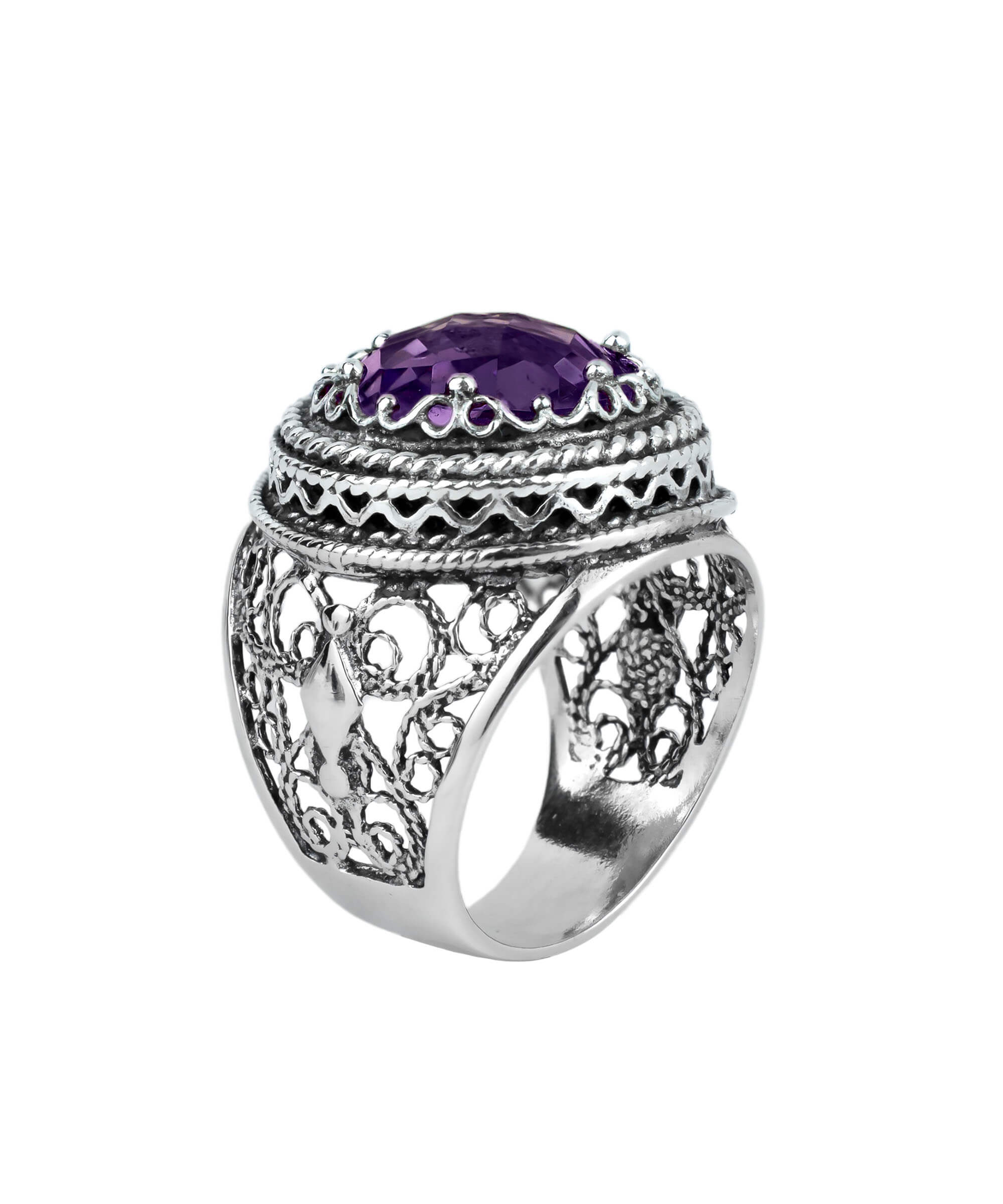 A stunning sterling silver filigree ring featuring a large round-cut amethyst gemstone, elegantly designed with intricate metalwork.