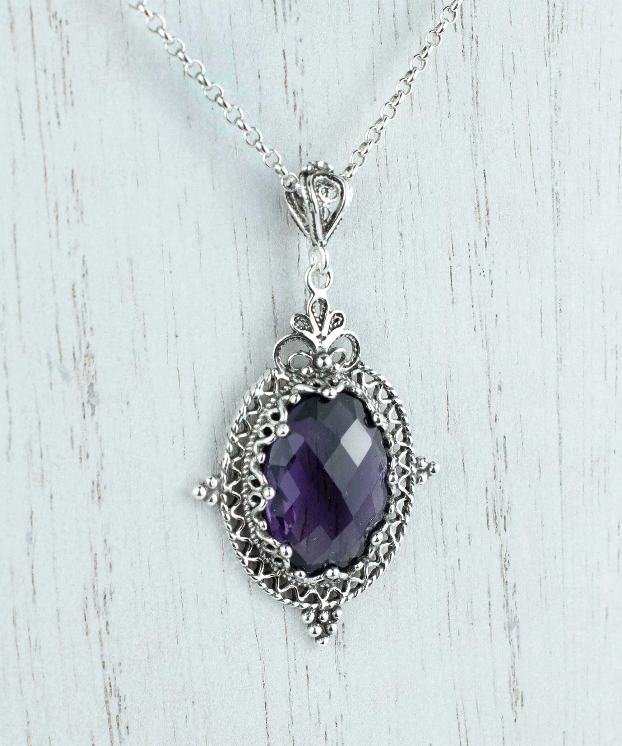 Elegant sterling silver filigree pendant necklace featuring a stunning amethyst gemstone in an oval shape, beautifully crafted for women.