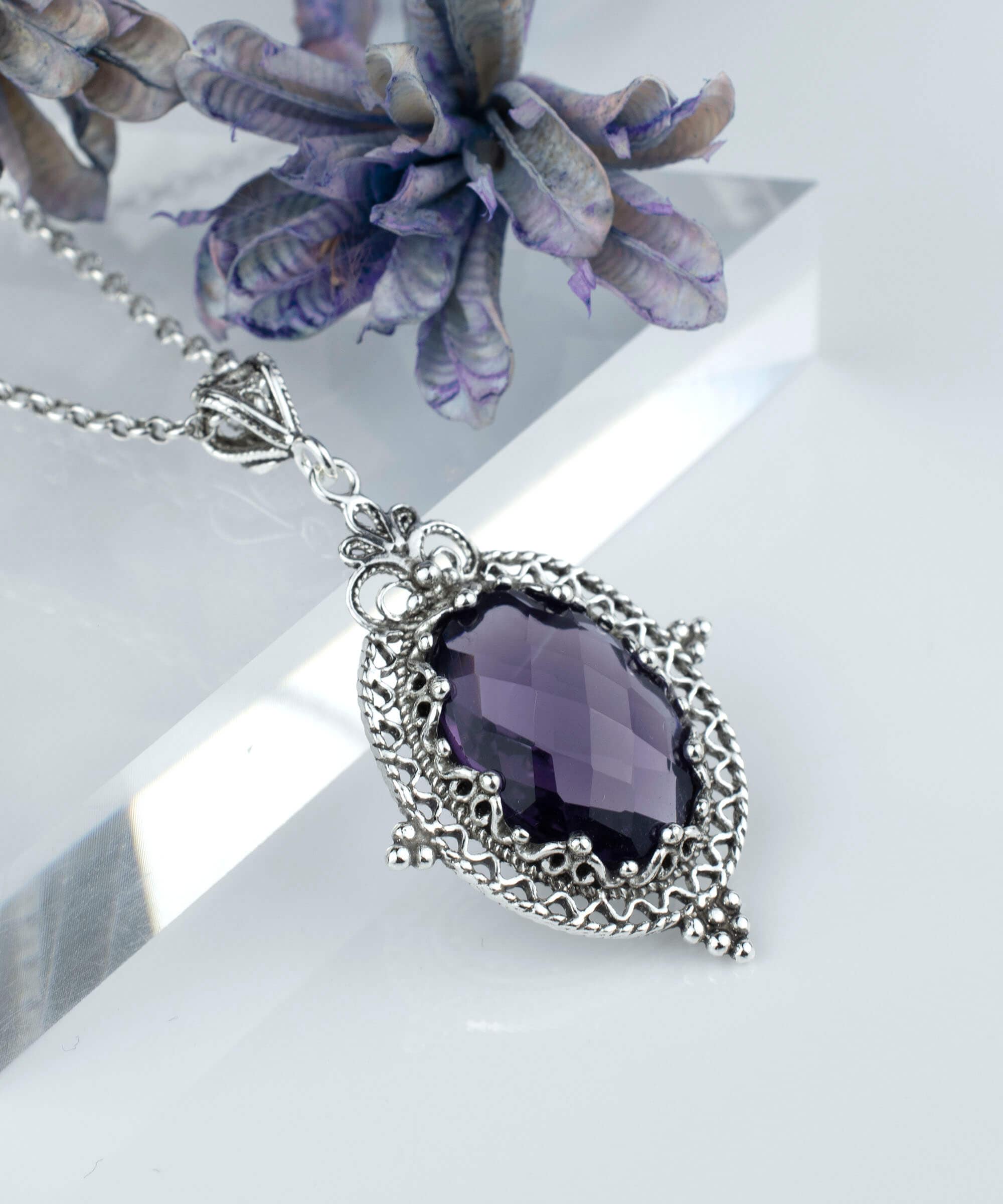 Elegant sterling silver filigree pendant necklace featuring a stunning amethyst gemstone in an oval shape, beautifully crafted for women.