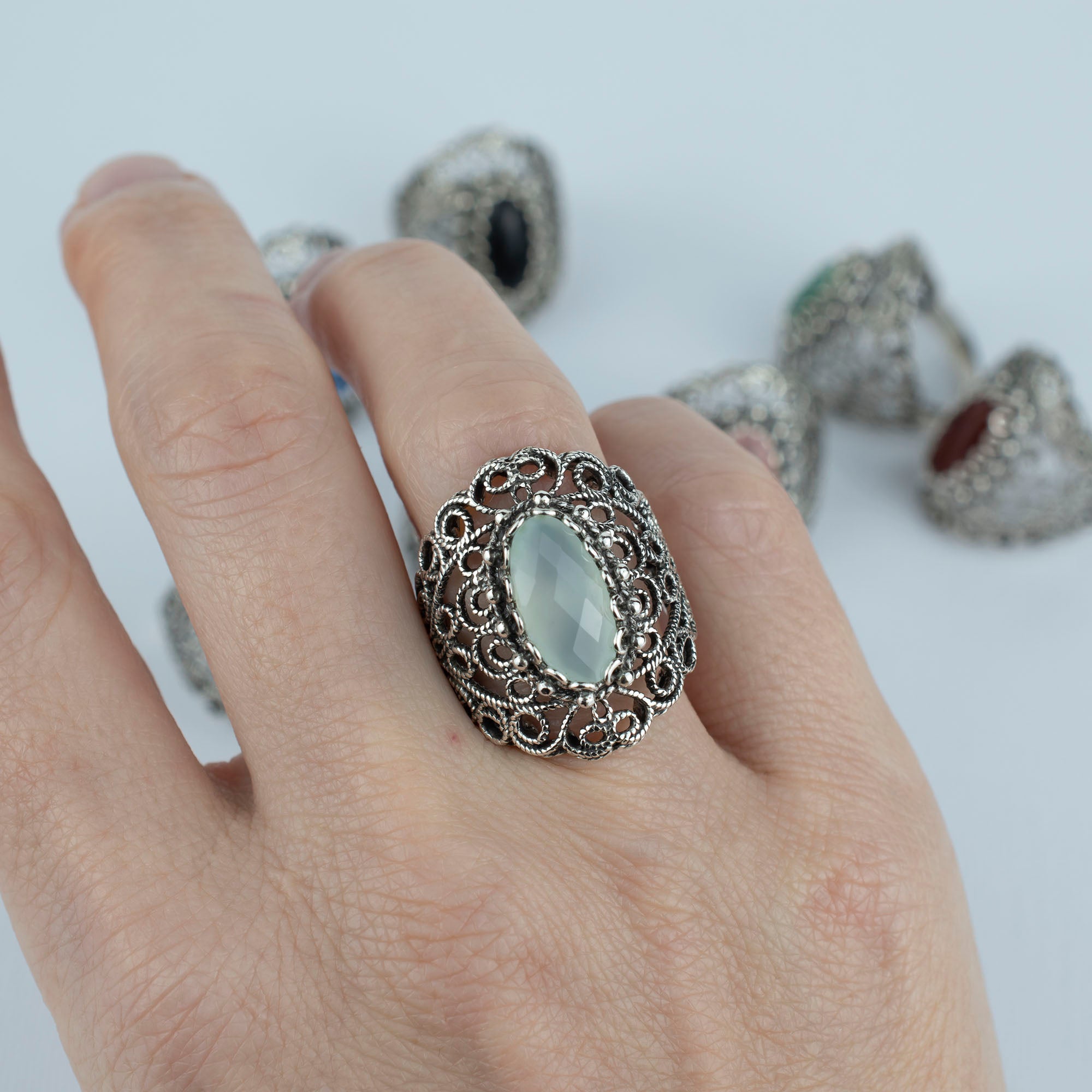 Handmade silver statement ring featuring aqua chalcedony gemstone in intricate filigree lace design.