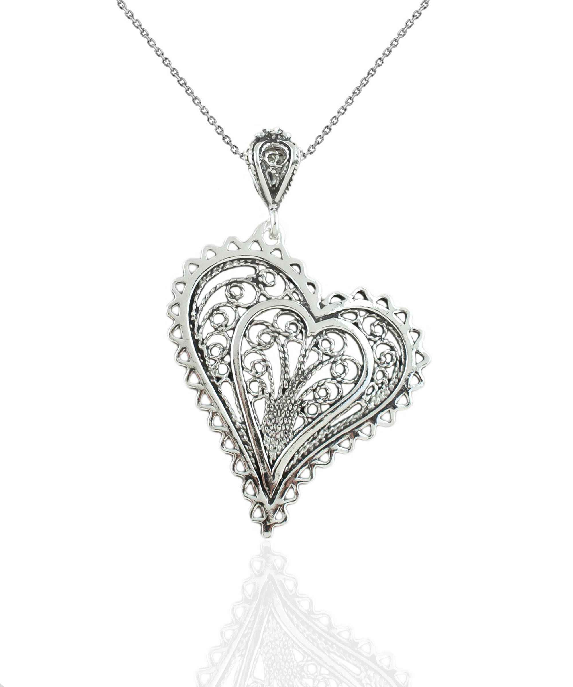 Elegant 925 Sterling Silver filigree heart pendant necklace with asymmetric design, displayed on a soft velvet background.