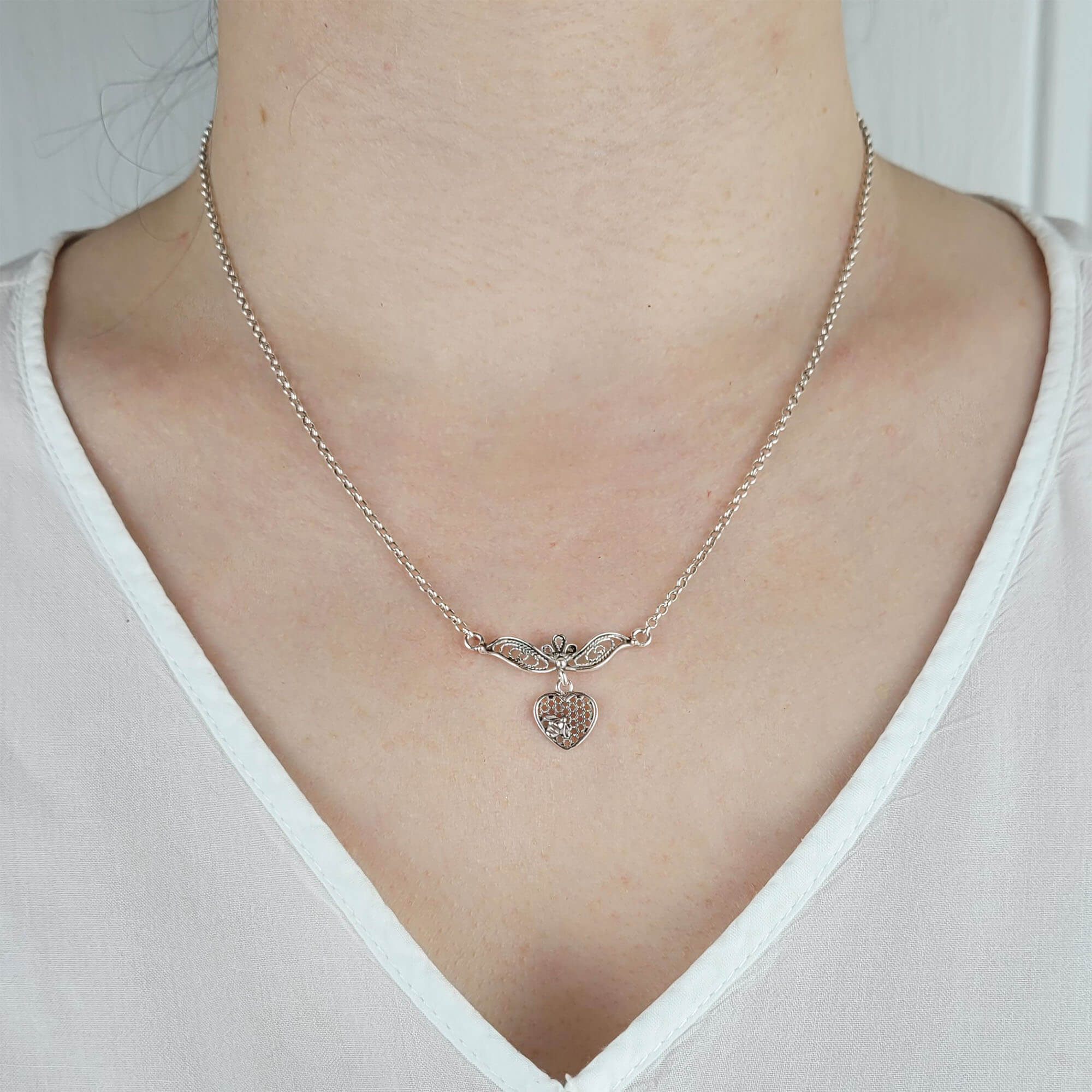 Elegant 925 sterling silver choker necklace featuring a filigree art design of a bee on a heart, showcasing intricate craftsmanship.