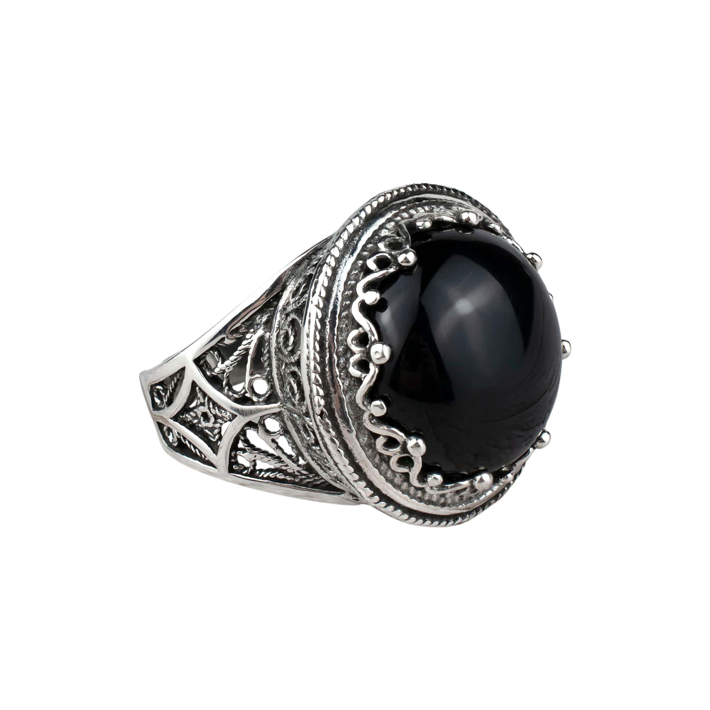 A bold statement ring featuring a black onyx gemstone set in intricate sterling silver filigree design, showcasing elegance and craftsmanship.