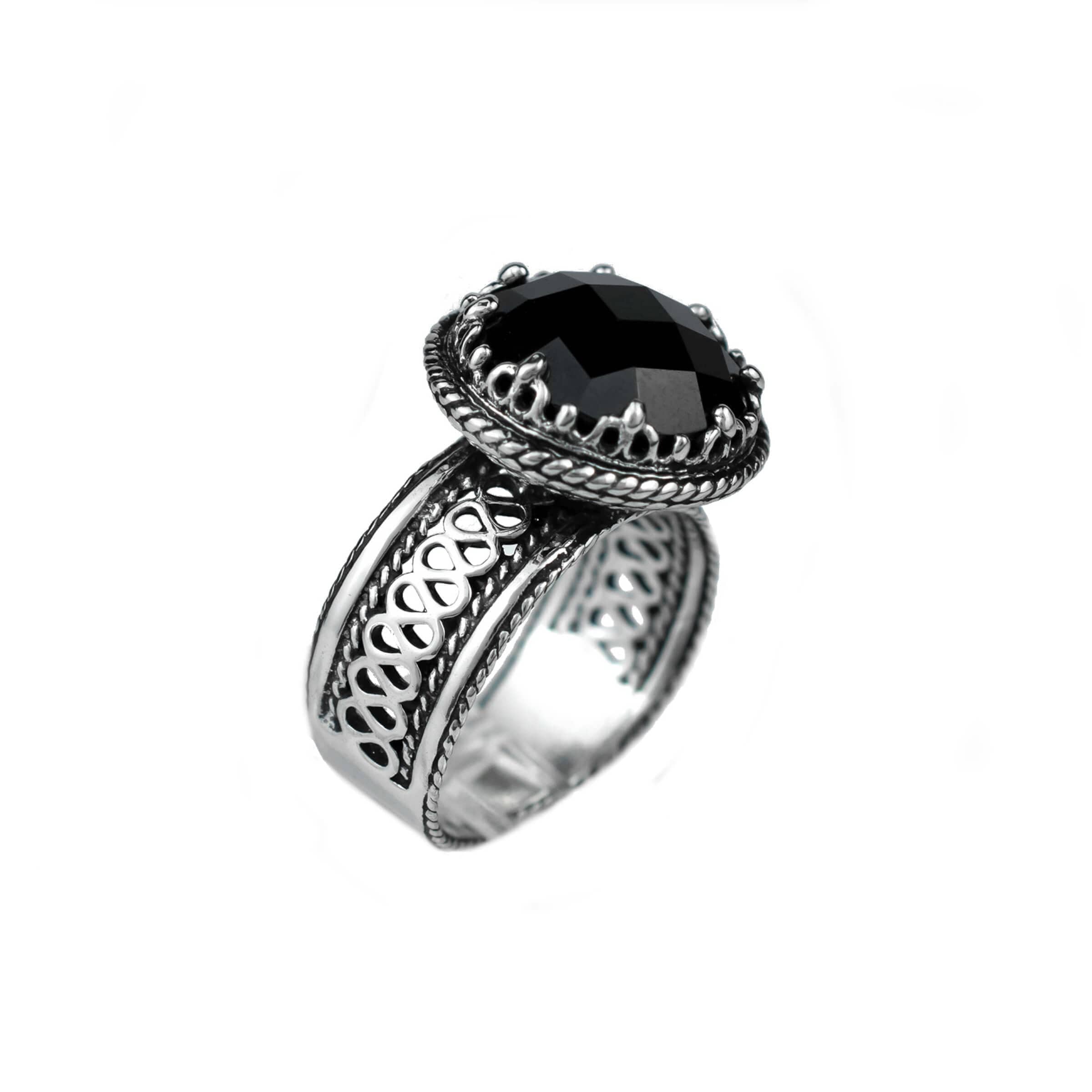 Elegant sterling silver cocktail ring featuring a black onyx gemstone with intricate filigree design.