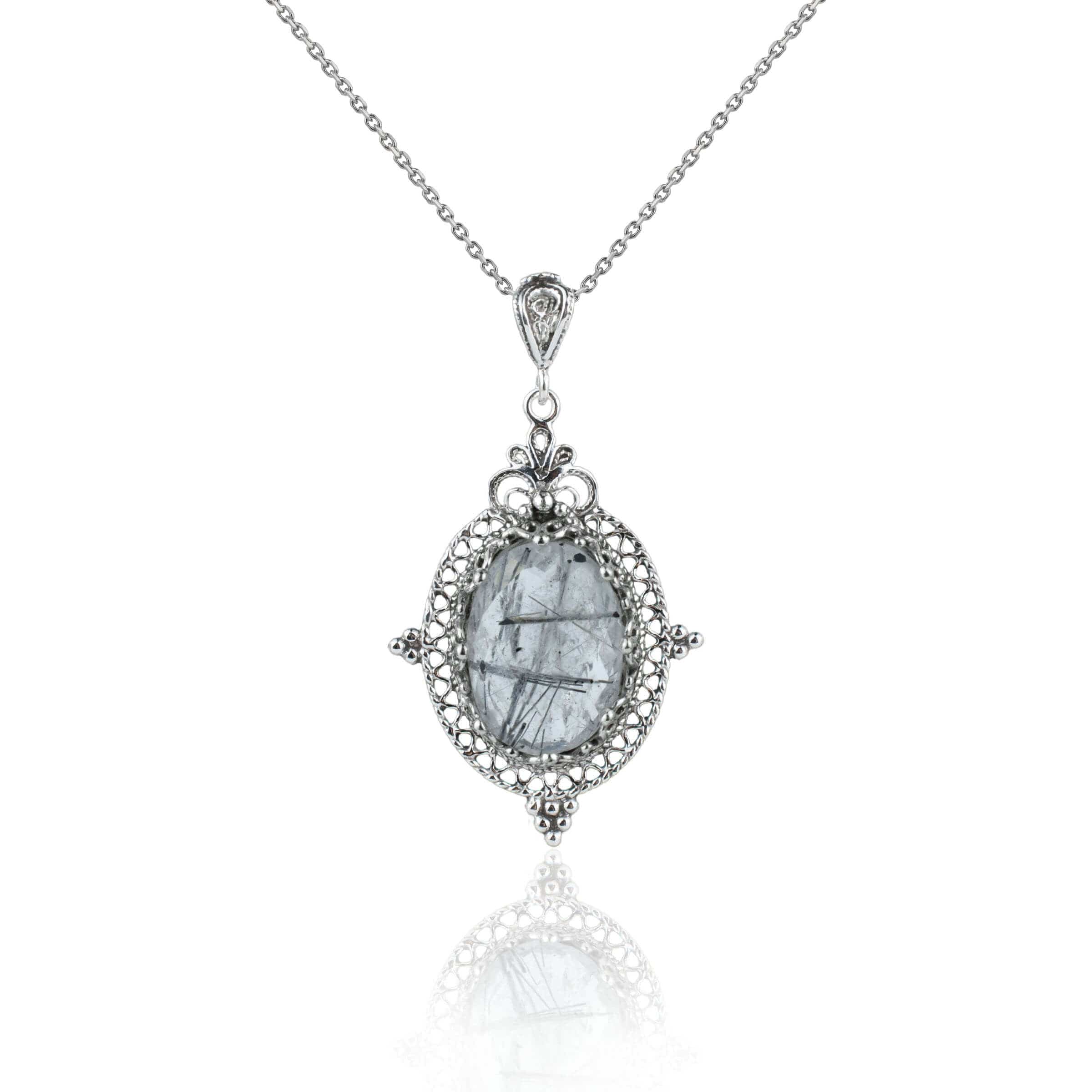 Elegant silver pendant necklace featuring a black rutile gemstone in a filigree design, showcasing intricate craftsmanship.