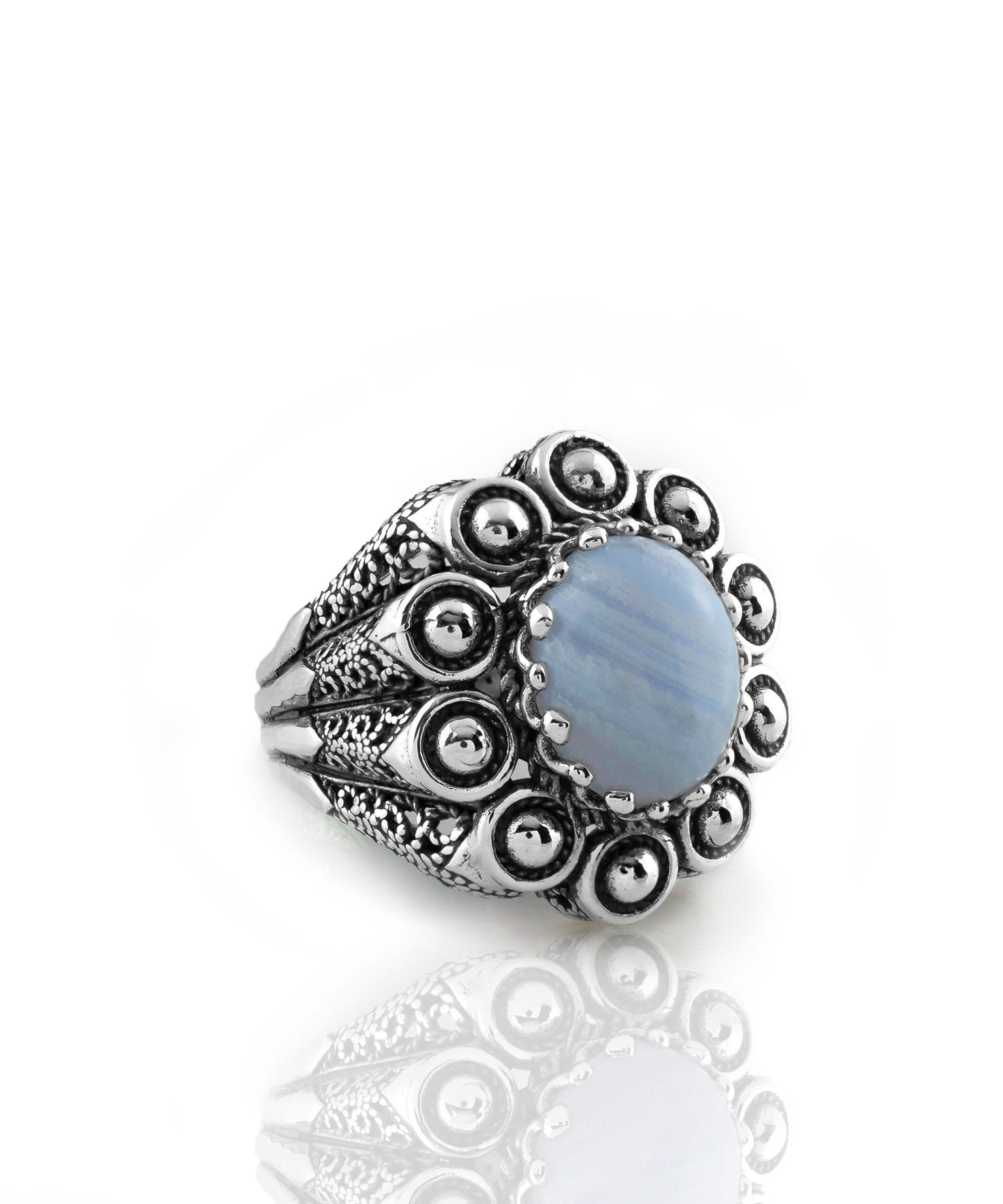 A handcrafted filigree art dome ring featuring a blue lace agate gemstone set in a 925 sterling silver band, showcasing intricate details and an antique finish.