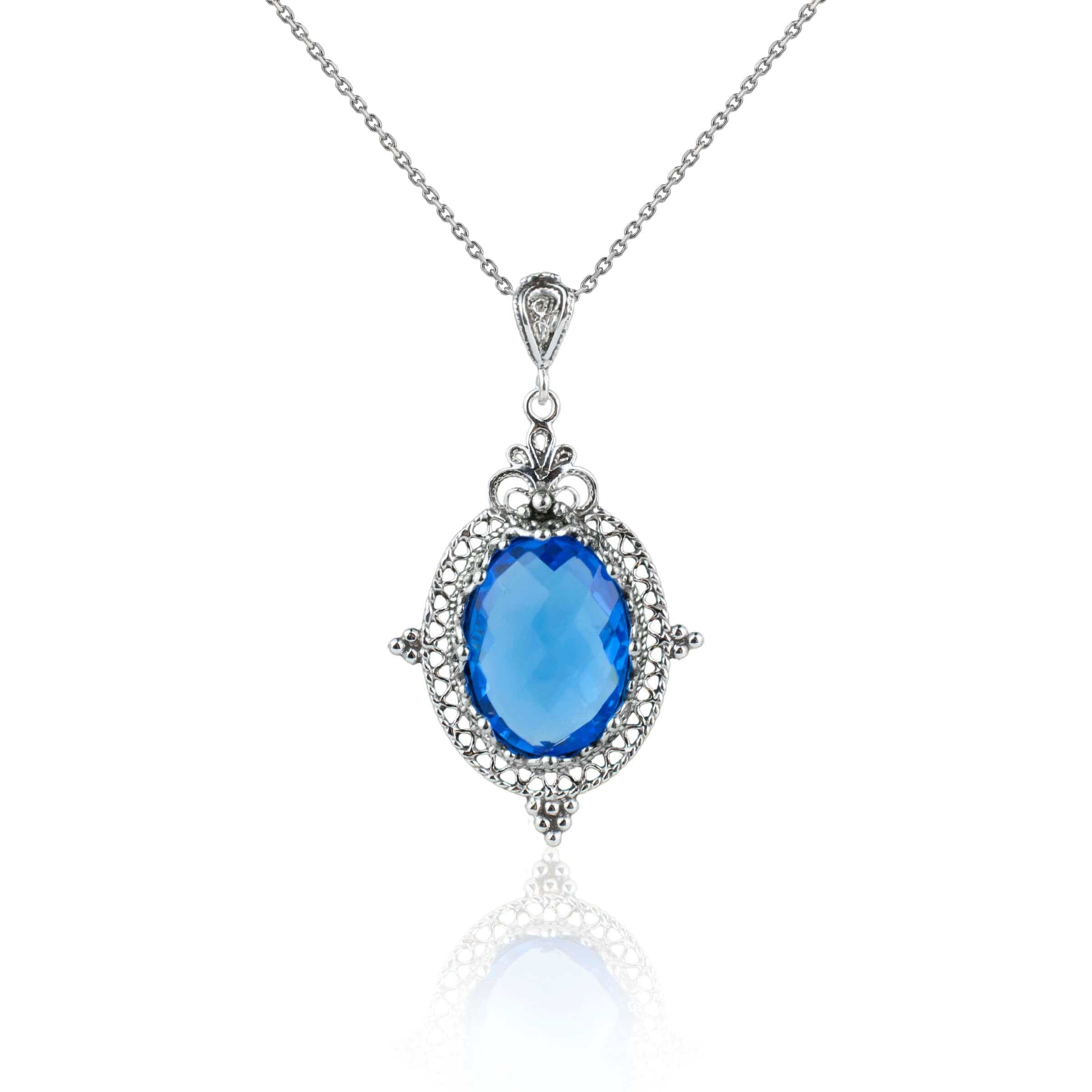 Sterling silver filigree art pendant necklace featuring a natural blue quartz gemstone, elegantly designed with intricate metalwork.