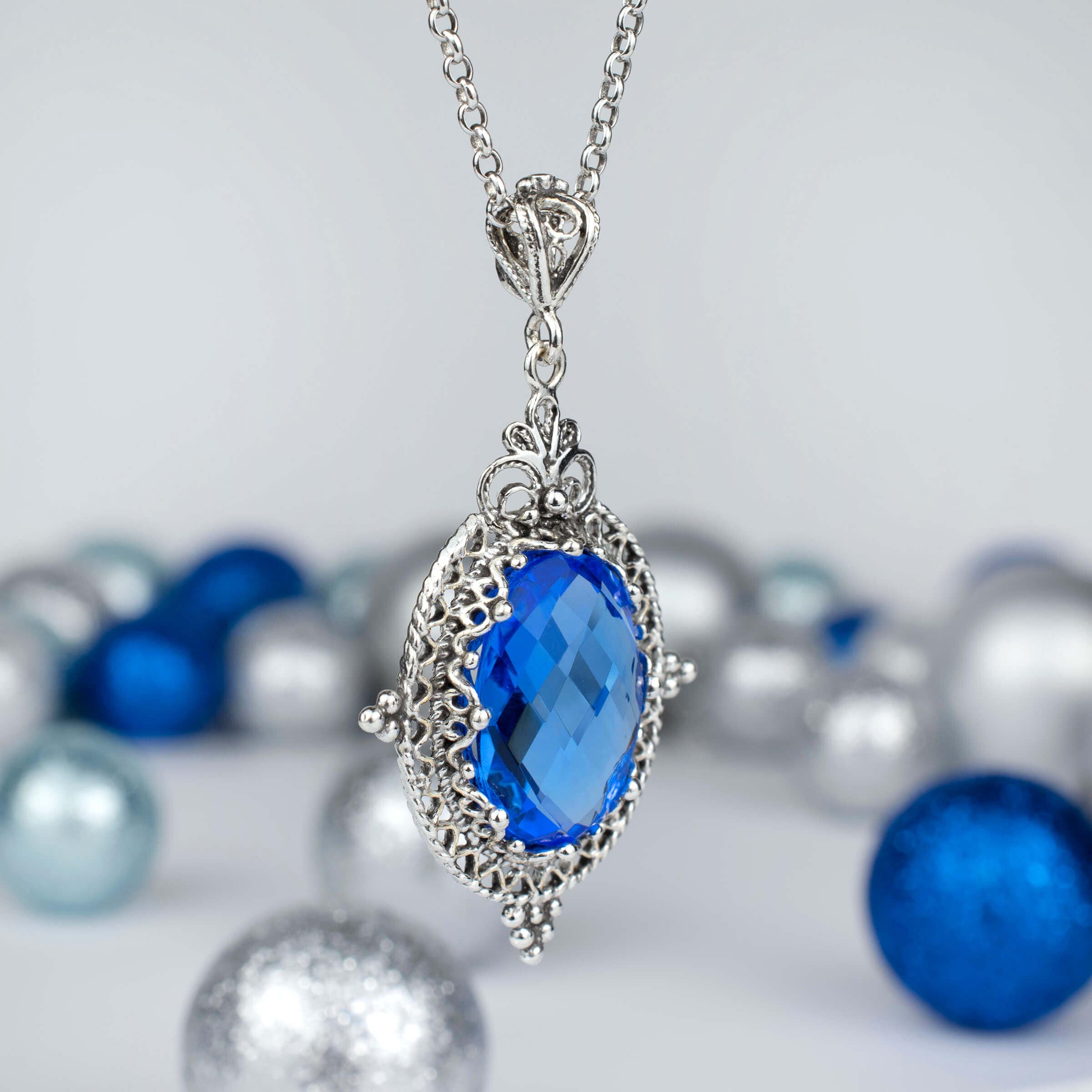 Sterling silver filigree art pendant necklace featuring a natural blue quartz gemstone, elegantly designed with intricate metalwork.