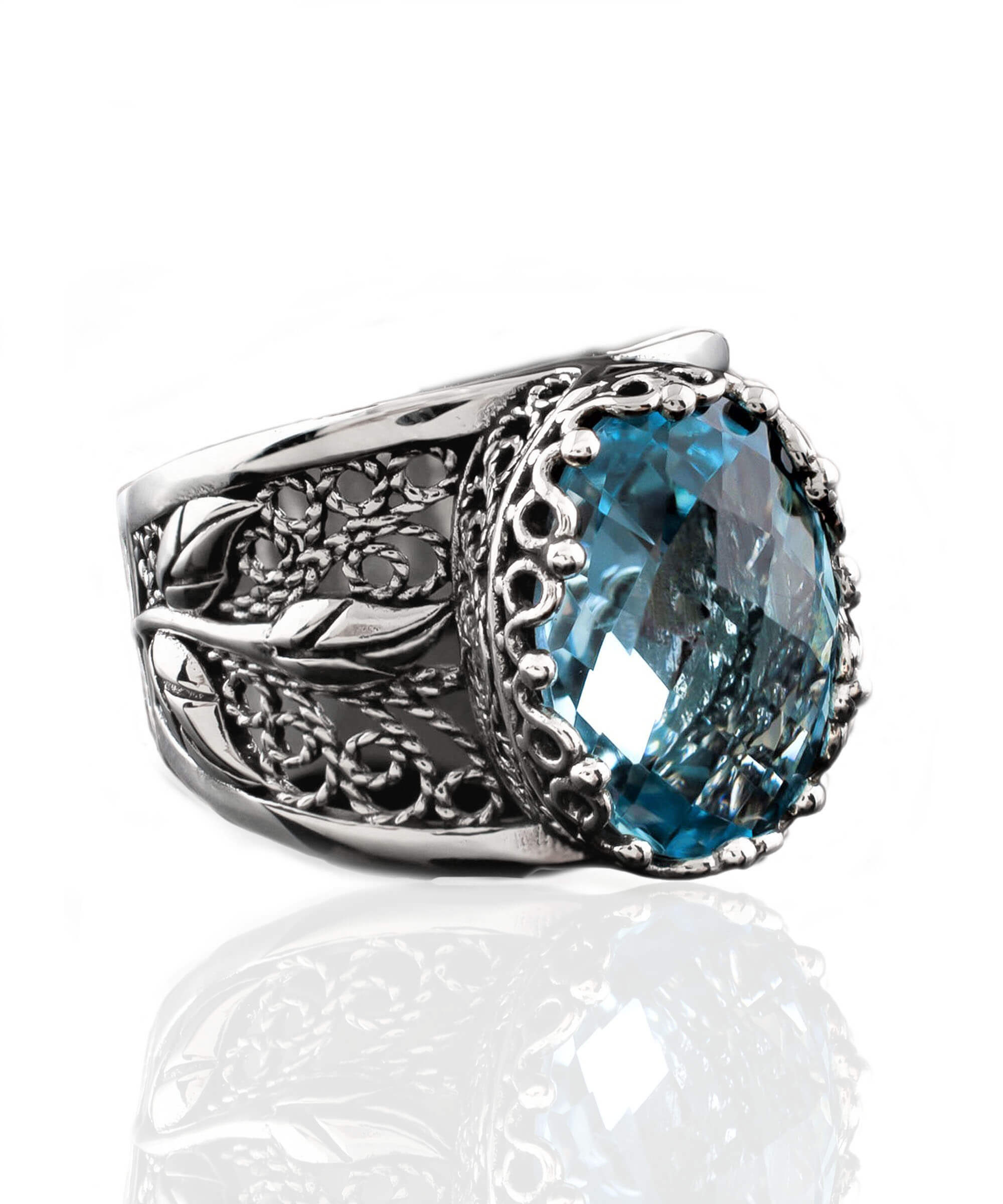 Elegant sterling silver cocktail ring featuring a blue topaz gemstone in a tulip filigree design, perfect for women.