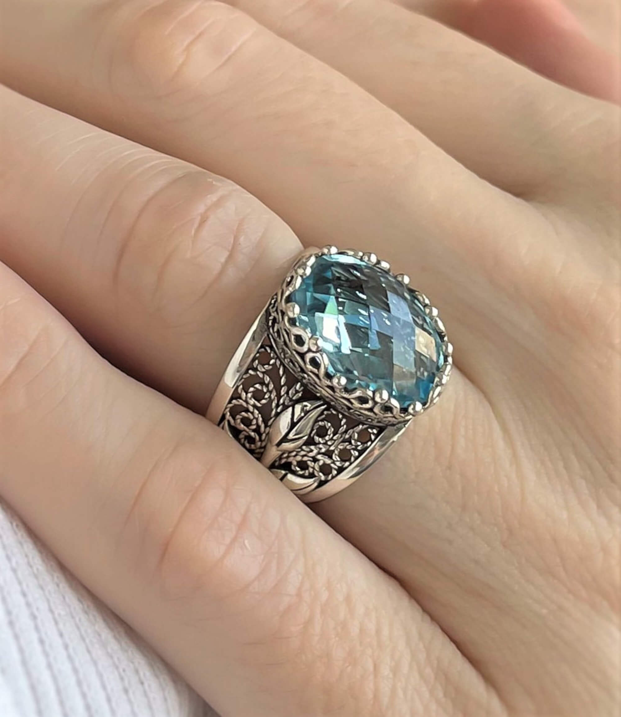 Elegant sterling silver cocktail ring featuring a blue topaz gemstone in a tulip filigree design, perfect for women.