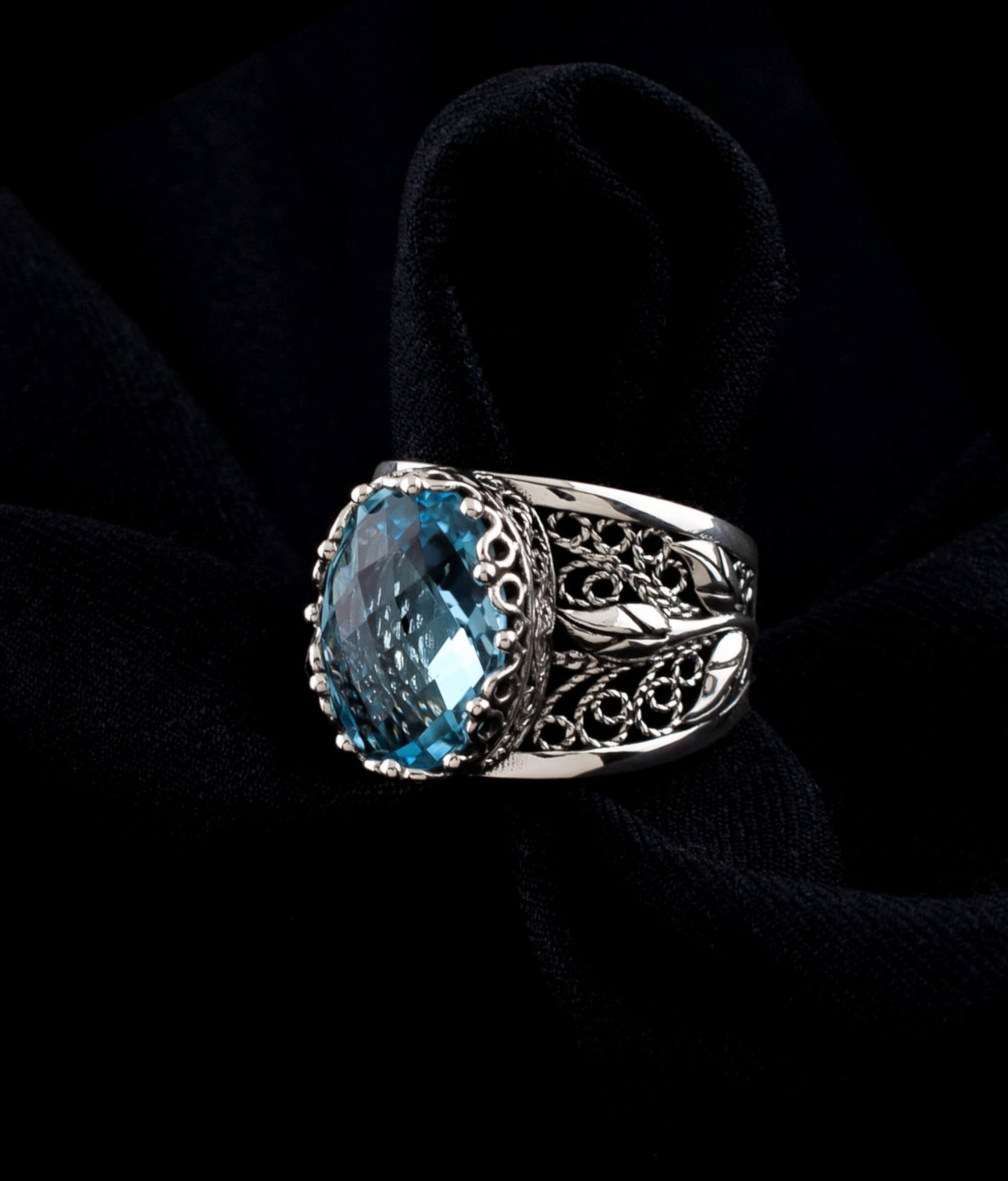 Elegant sterling silver cocktail ring featuring a blue topaz gemstone in a tulip filigree design, perfect for women.