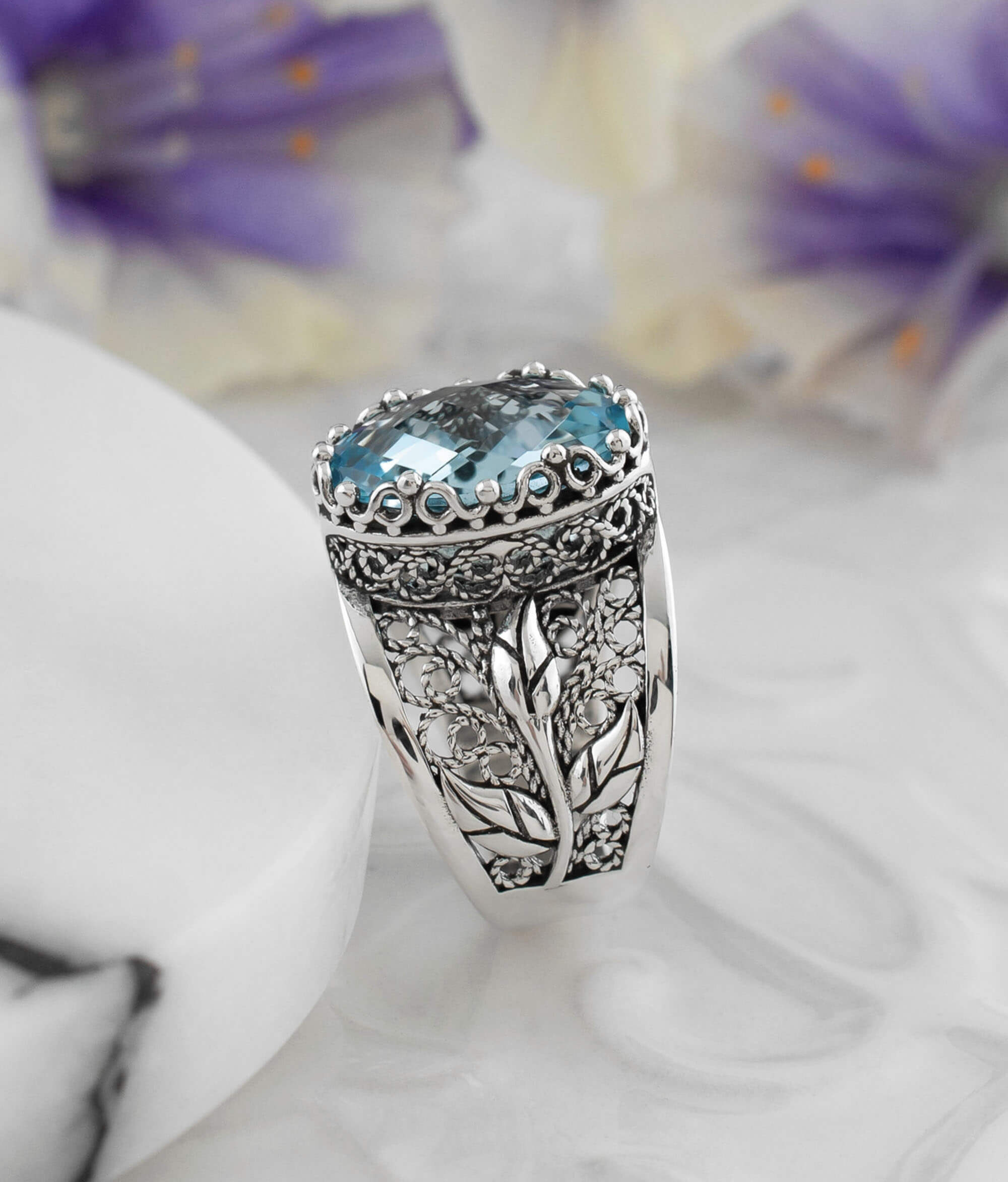 Elegant sterling silver cocktail ring featuring a blue topaz gemstone in a tulip filigree design, perfect for women.