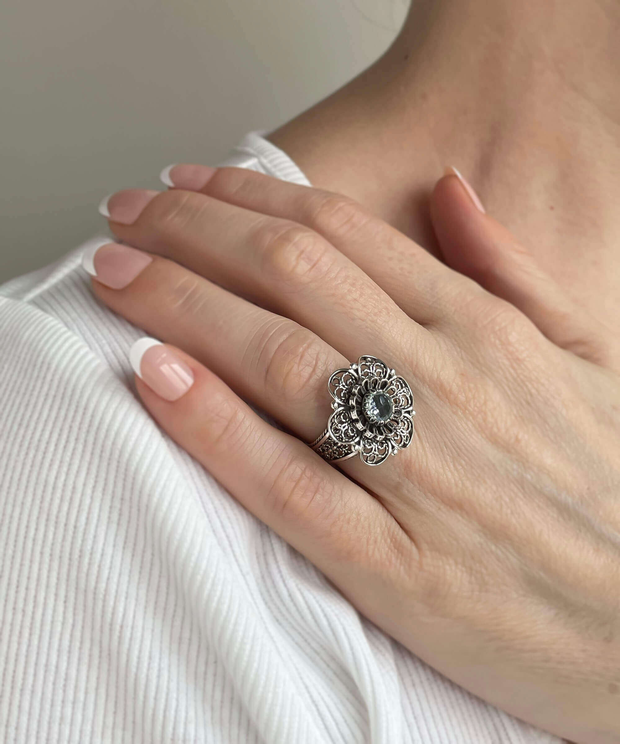 Elegant Filigree Art Blue Topaz Gemstone Women Silver Statement Ring with intricate lace flower design.