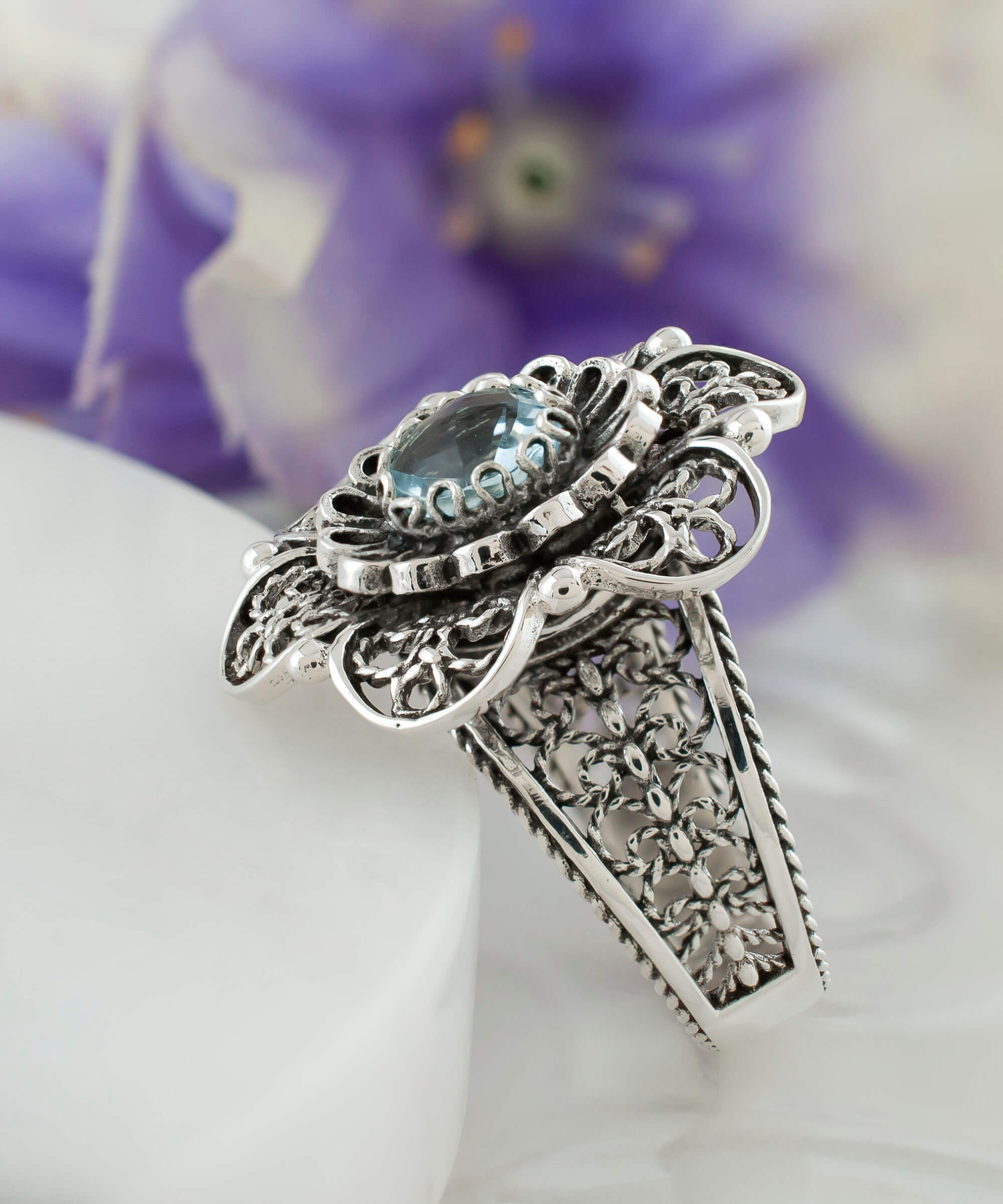 Elegant Filigree Art Blue Topaz Gemstone Women Silver Statement Ring with intricate lace flower design.