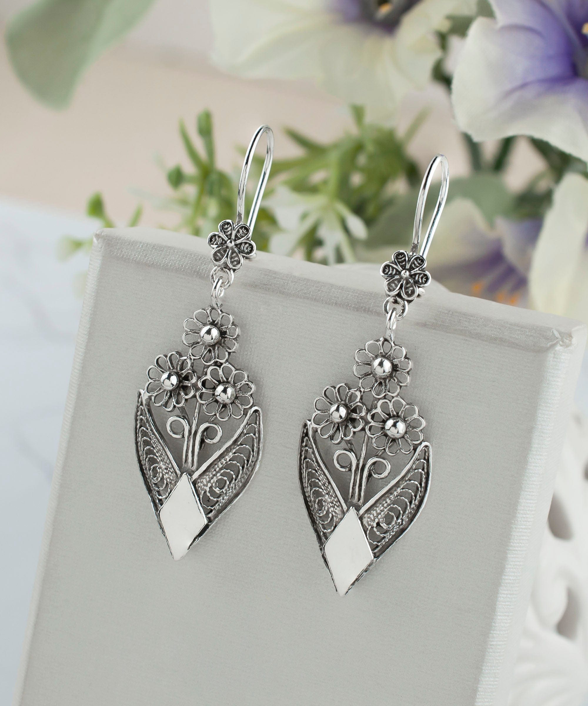 Handmade sterling silver dangle drop earrings featuring intricate filigree flower design, elegantly crafted for timeless beauty.