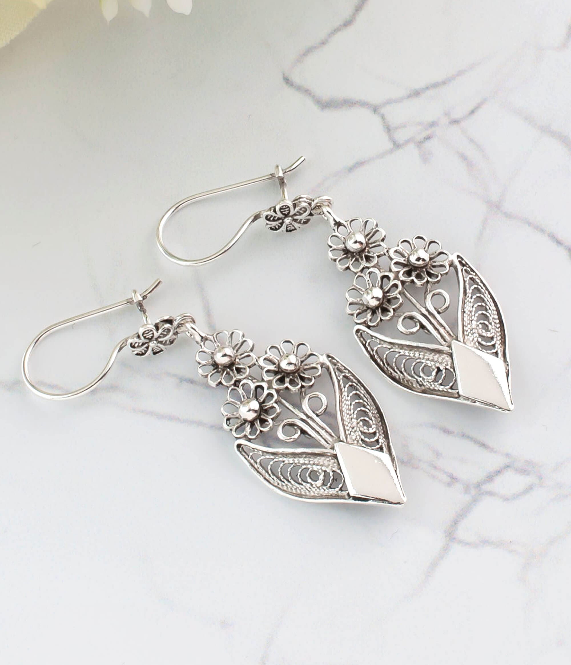 Handmade sterling silver dangle drop earrings featuring intricate filigree flower design, elegantly crafted for timeless beauty.