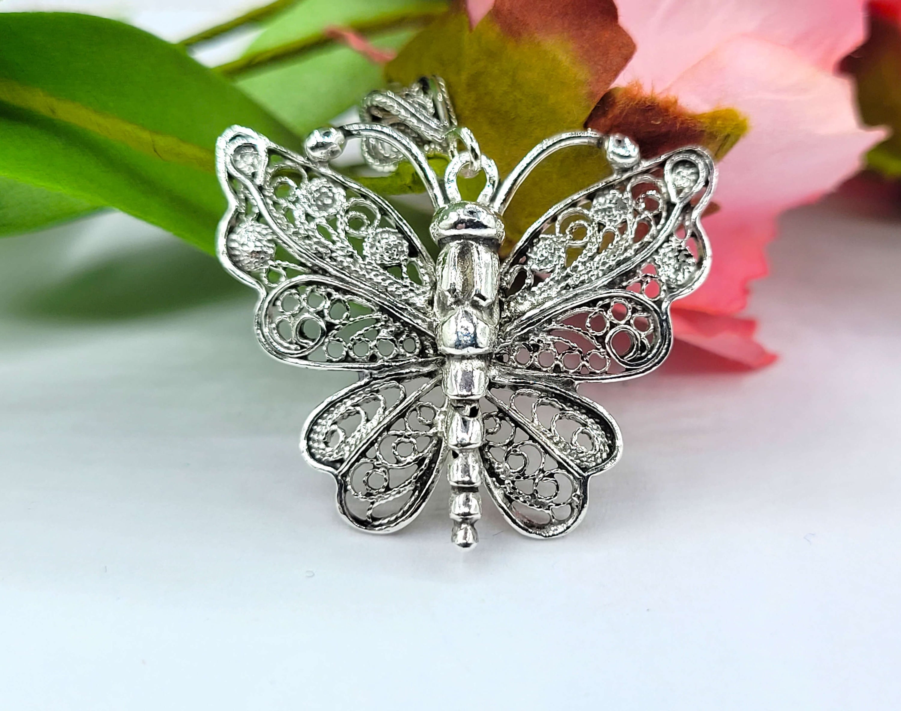 Sterling silver butterfly pendant necklace featuring intricate filigree design, displayed on a white background.